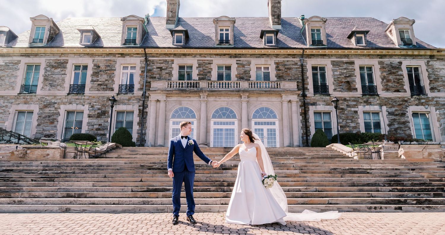 Grand historic mansion exterior with stone steps and classic architecture captured during a wedding.