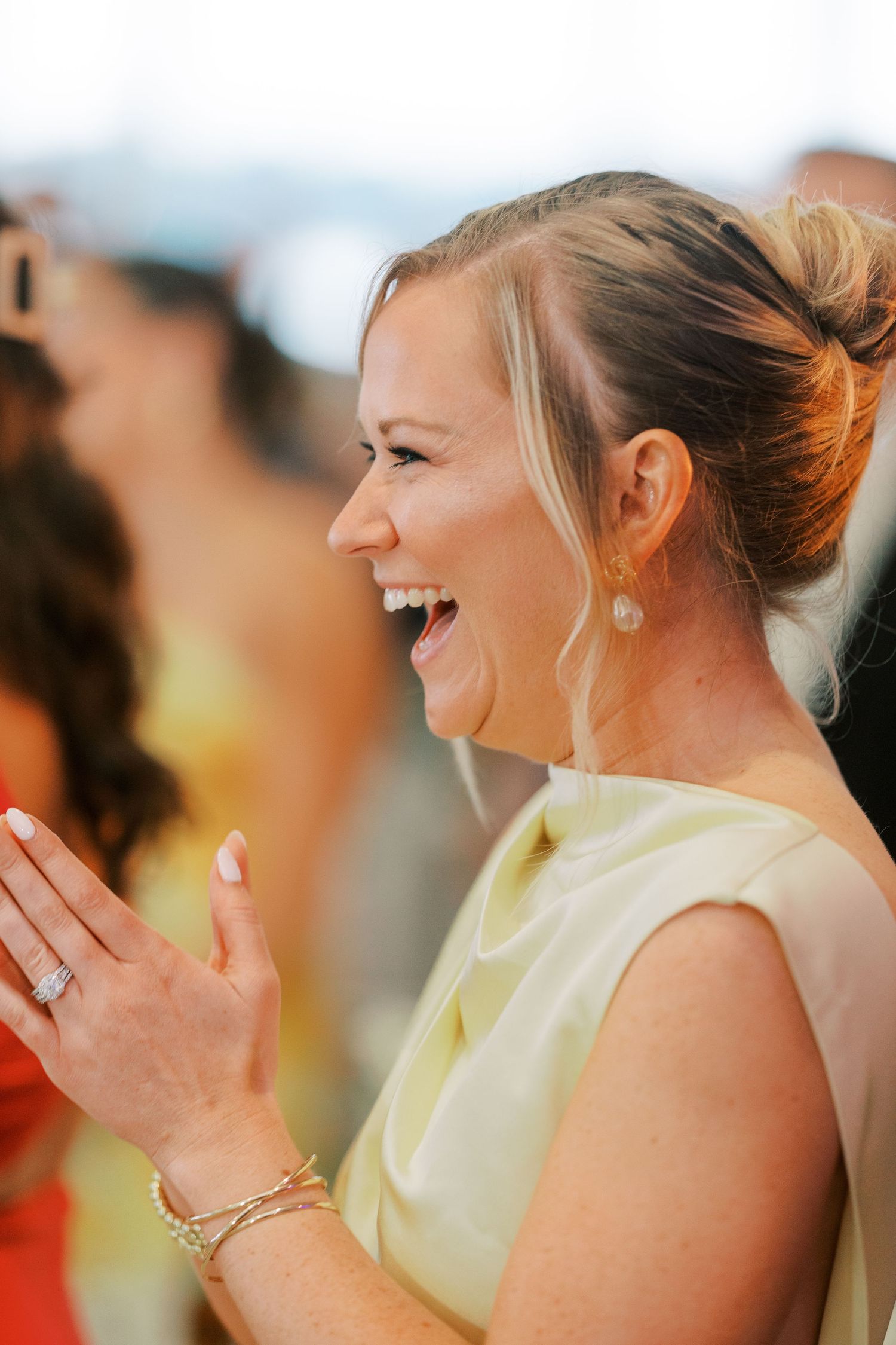 A person in a light yellow dress laughs joyfully in a series of candid photos showing genuine emotion.