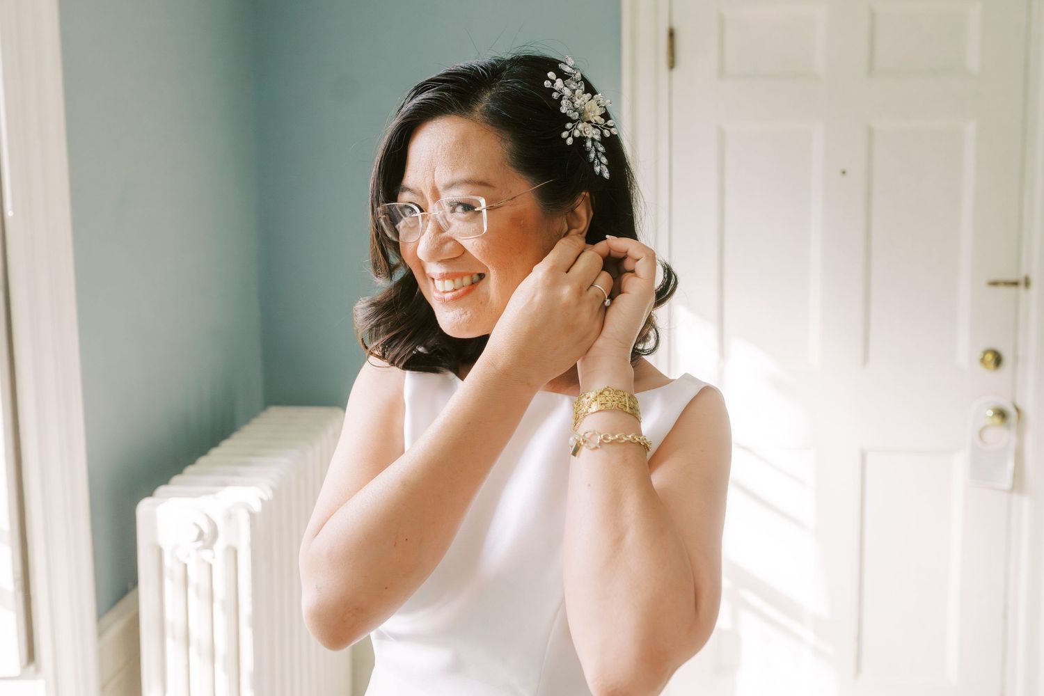 Wedding day preparation scene with white decor and emotional moments being captured.