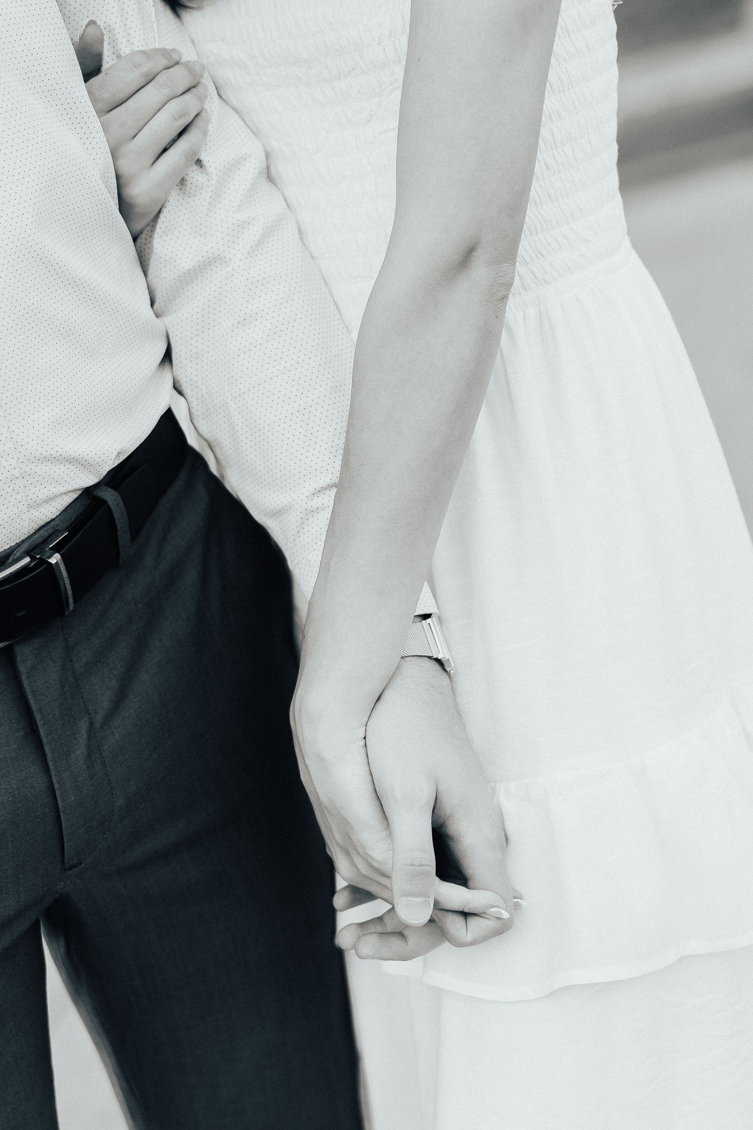 Close-up details of a couple's white and navy formal attire during an engagement photoshoot.