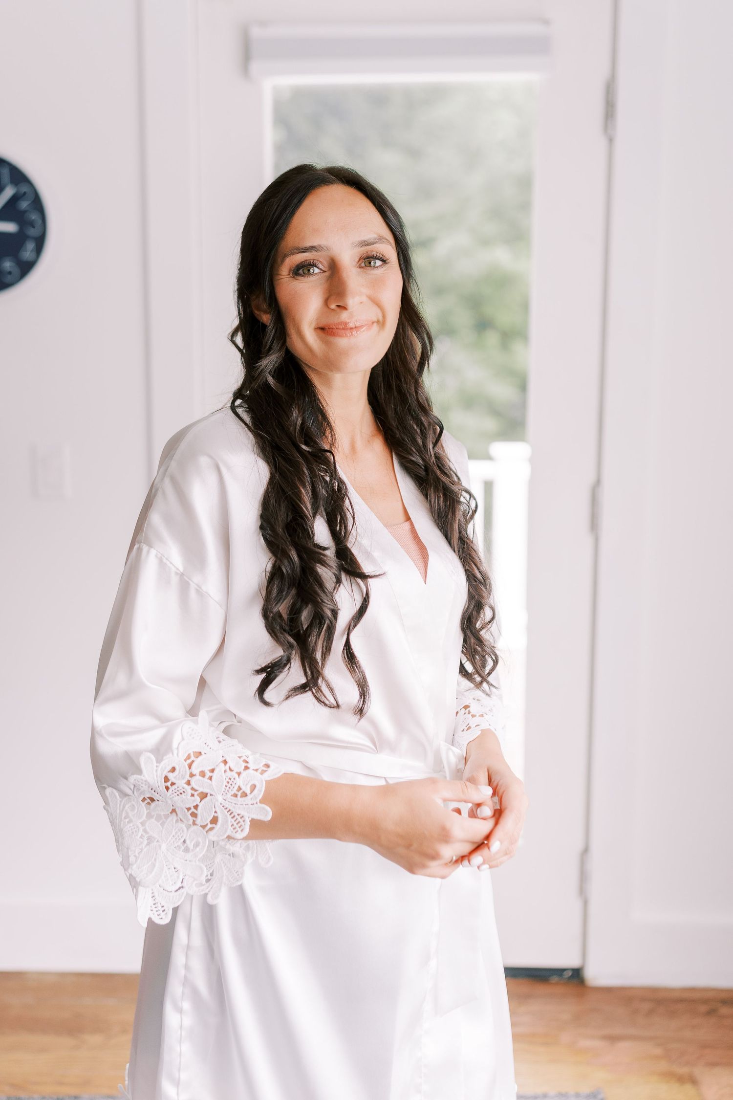 A person wearing a white silk robe sits in an elegant bridal setting.