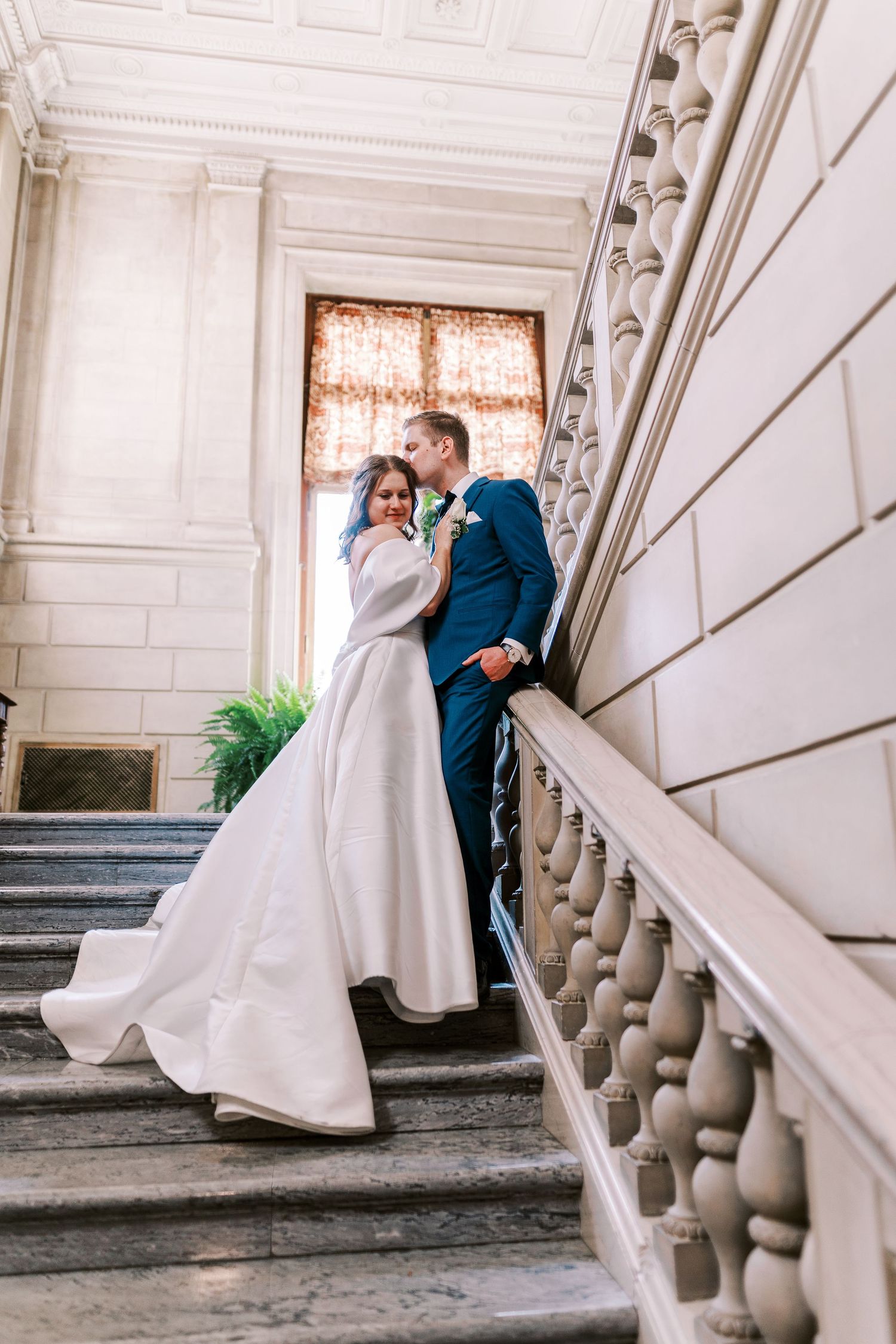 A series of romantic wedding photos showing a couple in formal attire sharing intimate moments on elegant stone steps.
