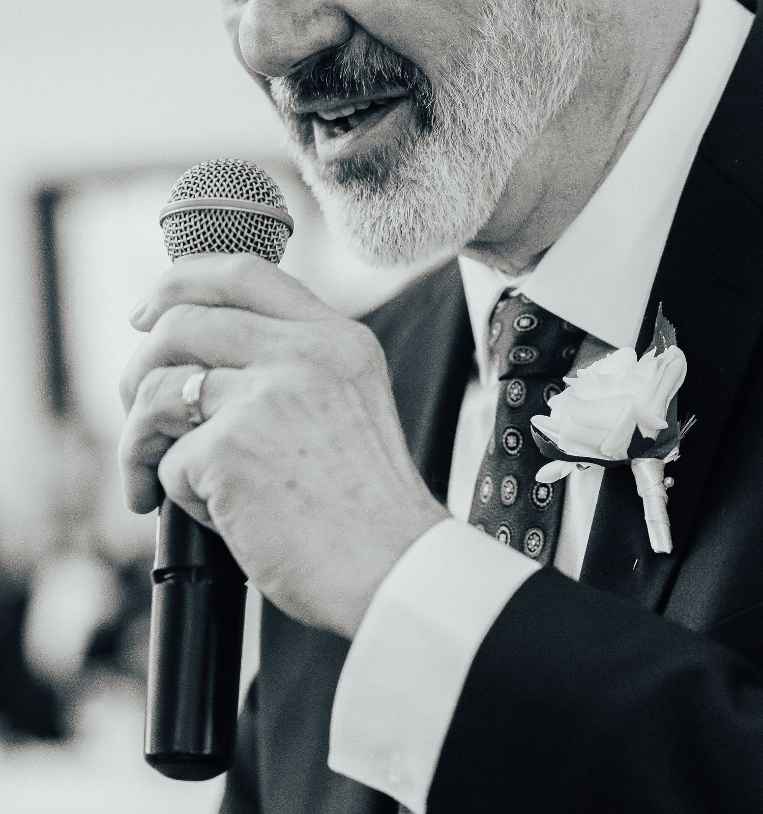 Close-up view of someone speaking into a microphone at a formal event.
