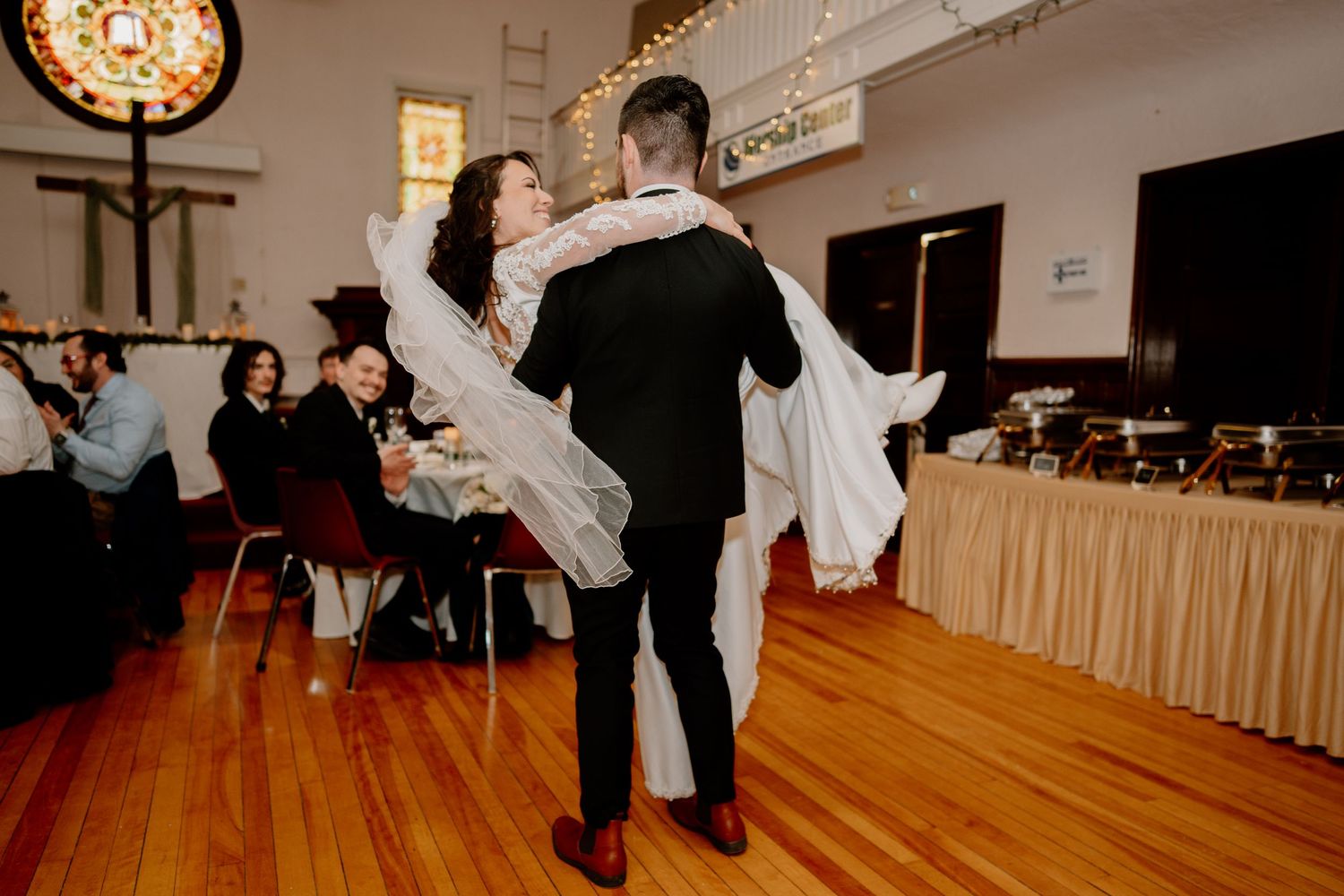 A couple performs a dramatic dip during their first dance at their wedding reception.