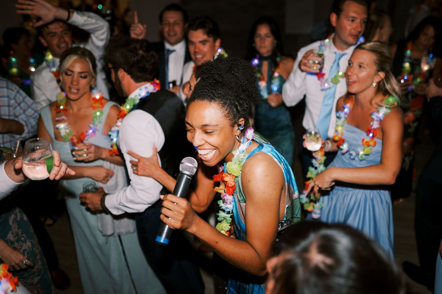 People dancing and celebrating together at a lively wedding reception party on the dance floor.