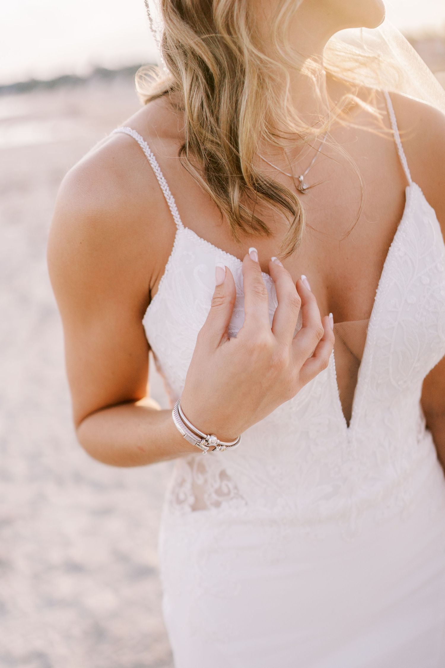 Close-up detail shots of a white lace wedding dress bodice with delicate straps and sweetheart neckline.