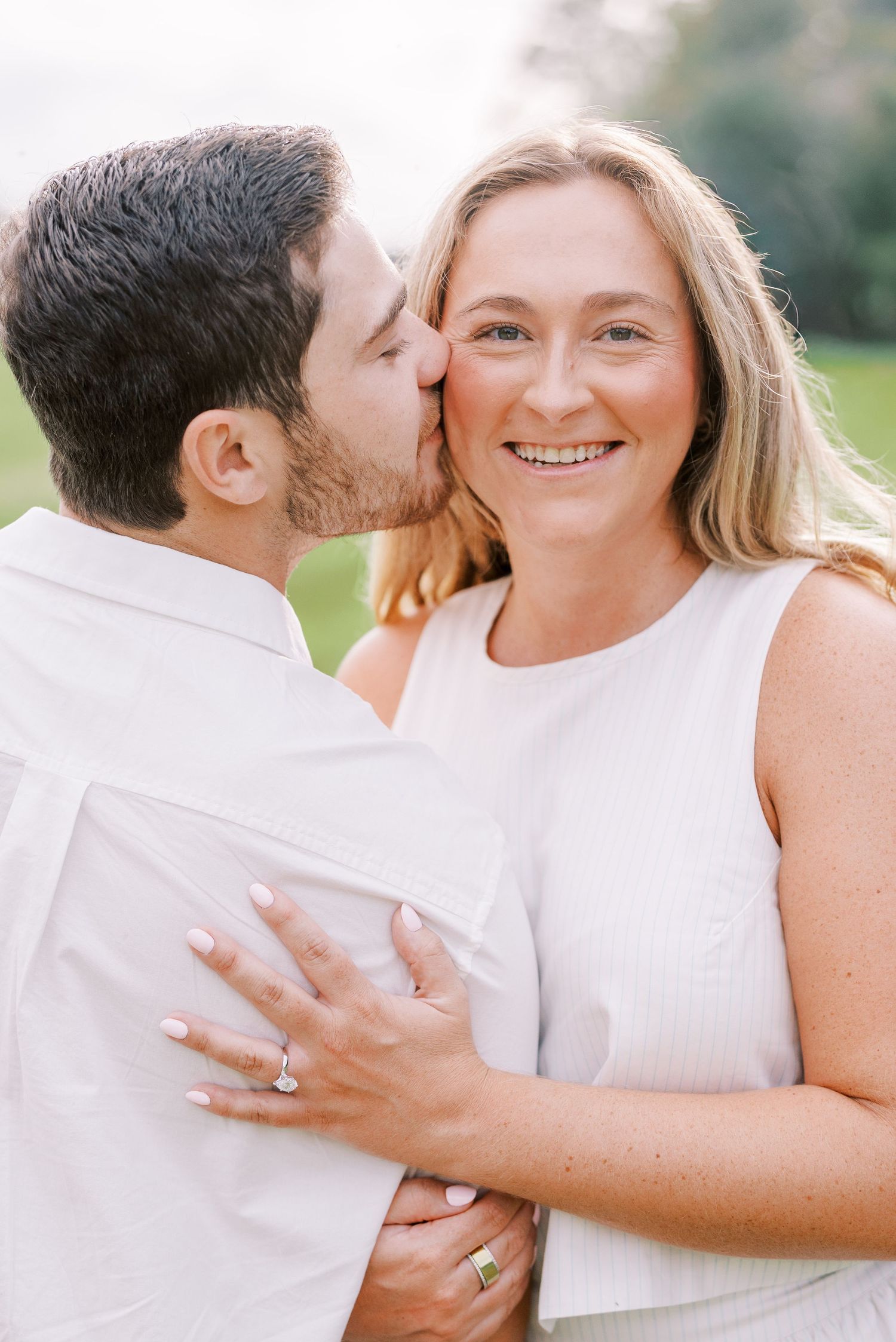 Intimate engagement photos showing joyful moments and a sparkling ring.