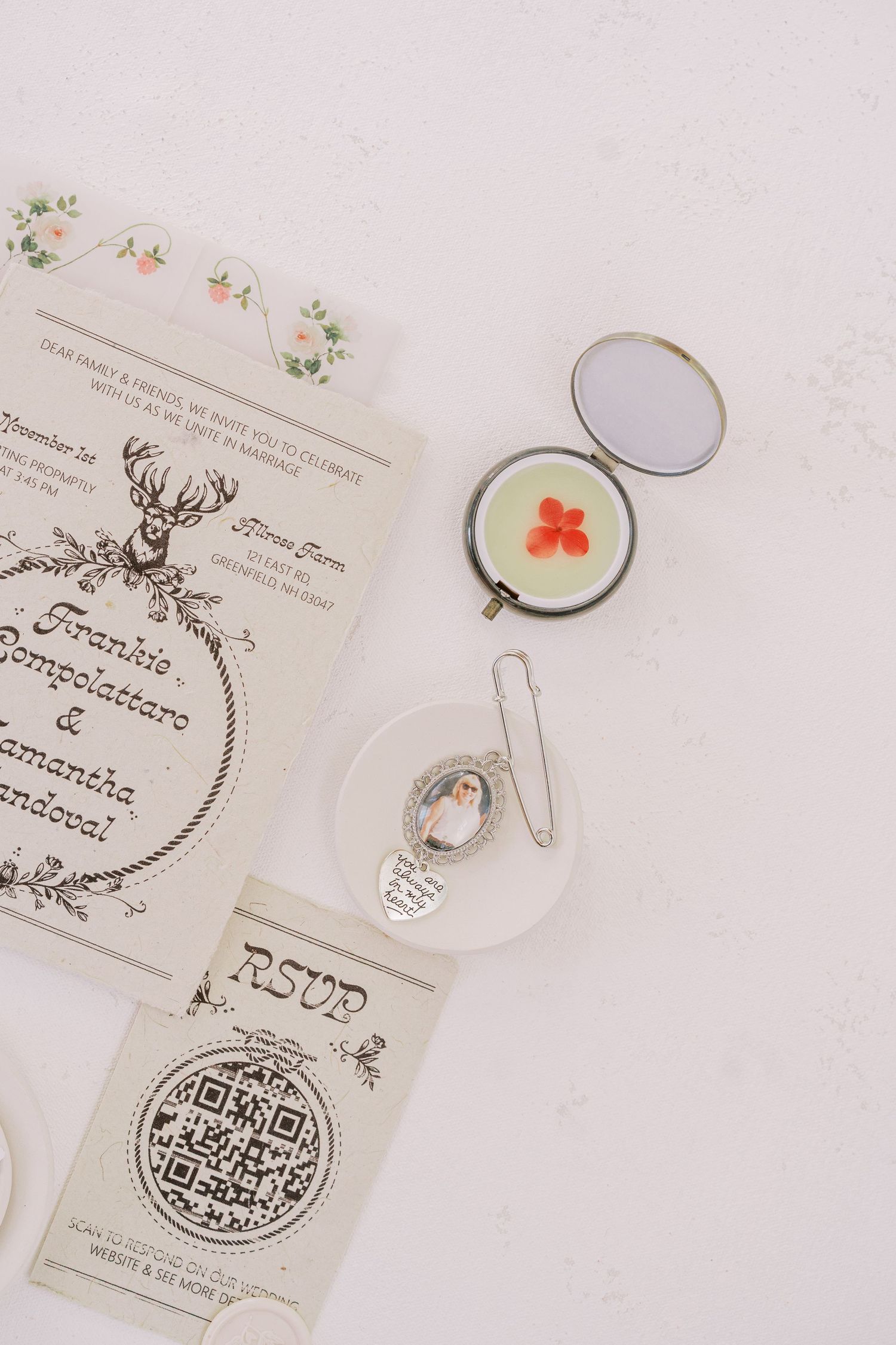 Wedding stationery set featuring elegant white cards with ornate designs and QR codes arranged on a light background.