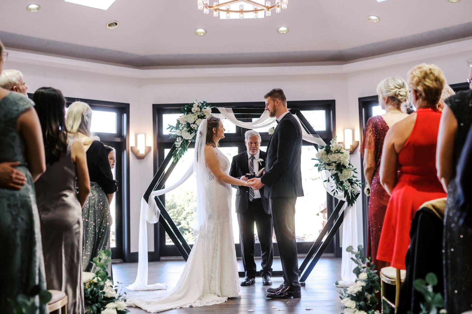 Wedding ceremony and reception space with elegant lighting and decor.