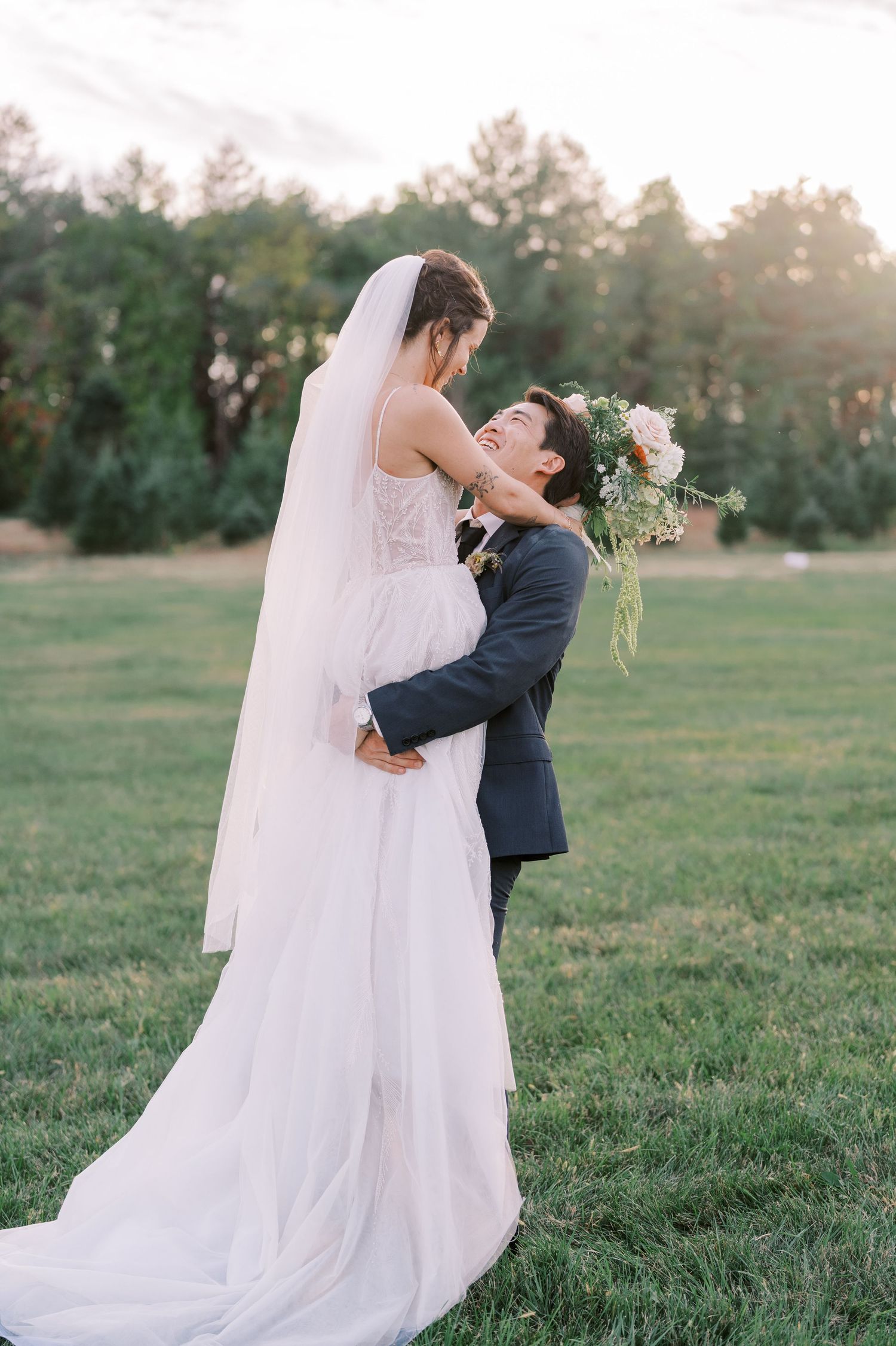 Couple sharing intimate dance moves on a sunlit lawn during their wedding photoshoot.