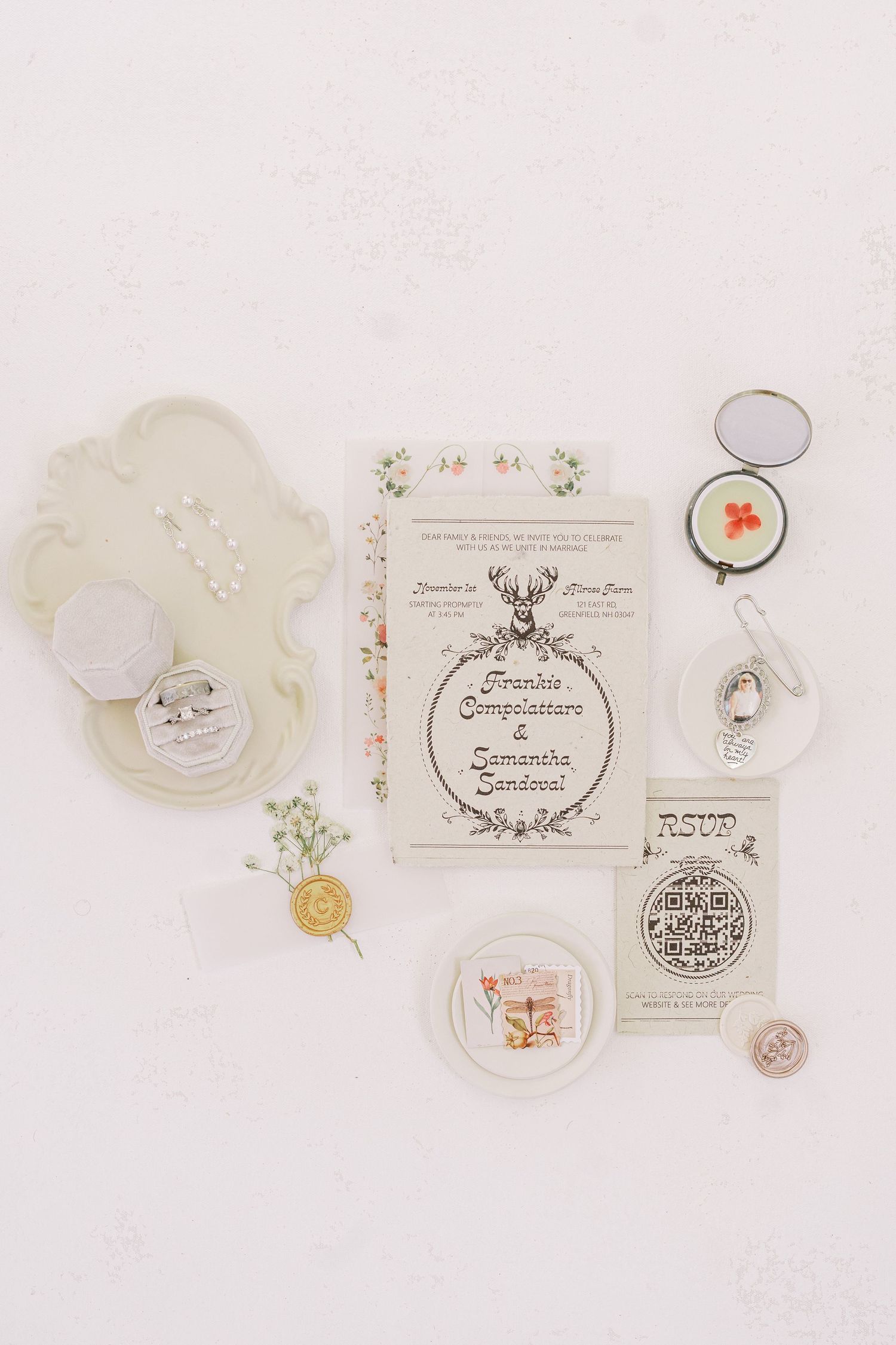 Vintage style beauty products and accessories arranged on white surface with delicate floral elements and paper labels.