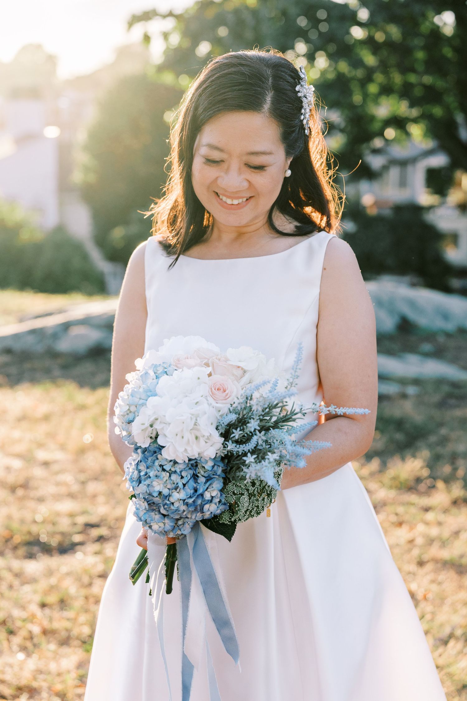 A wedding photo series featuring a white dress and blue hydrangea bouquet in natural sunlight.