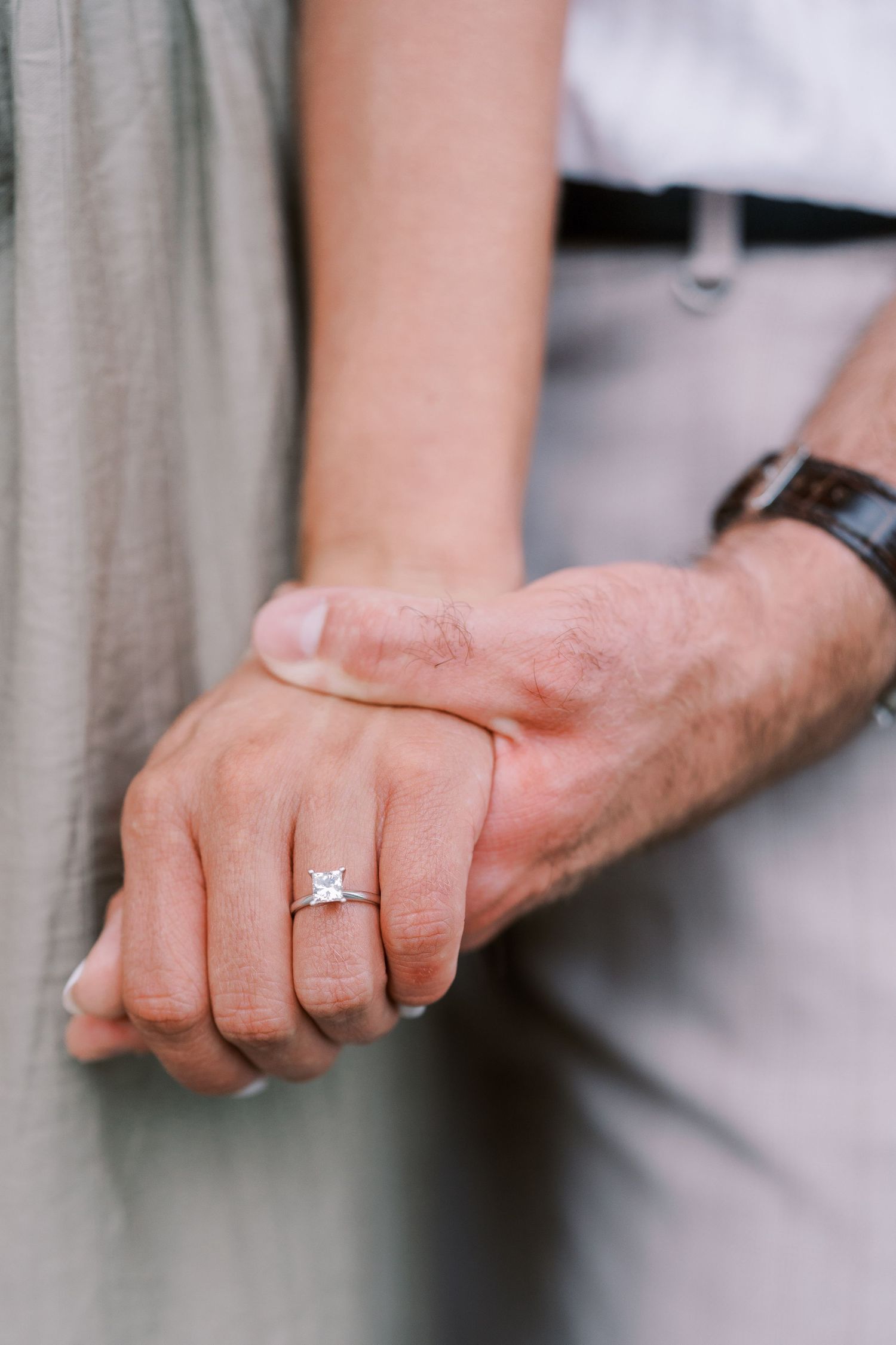 Close-up shots of hands showing an engagement ring in natural lighting.