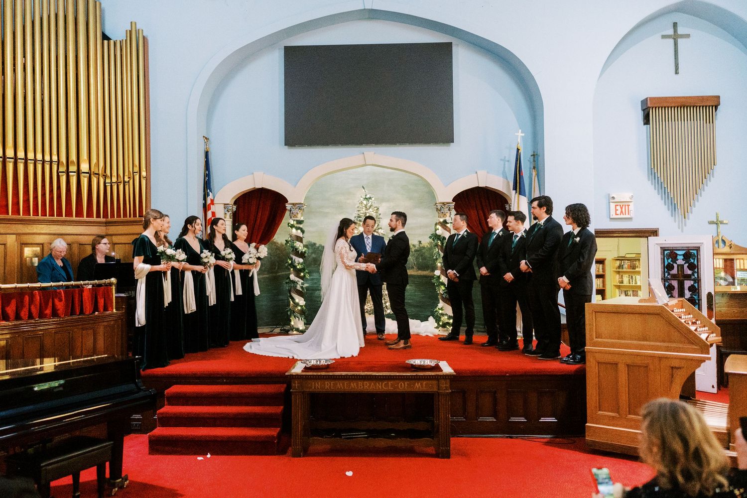Wedding ceremony in traditional church with arched ceilings and wooden pews.