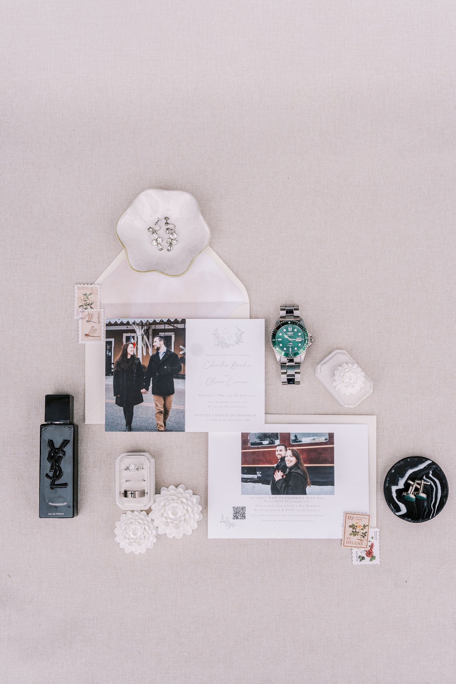 A minimalist white shelf display featuring decorative items, photographs and small ornaments arranged in a linear layout.