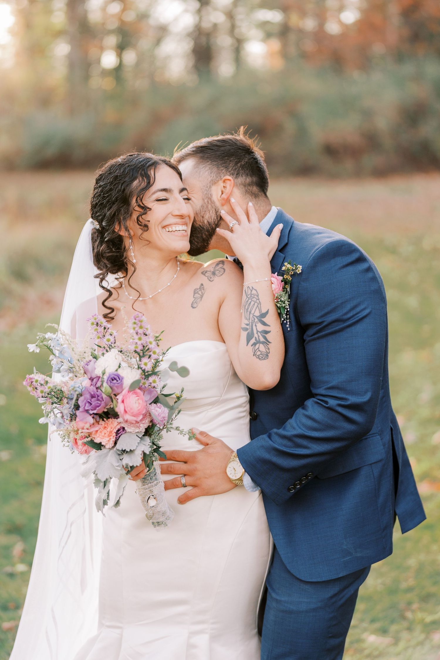 A romantic wedding couple shares tender moments in a series of photos with autumn foliage in the background.