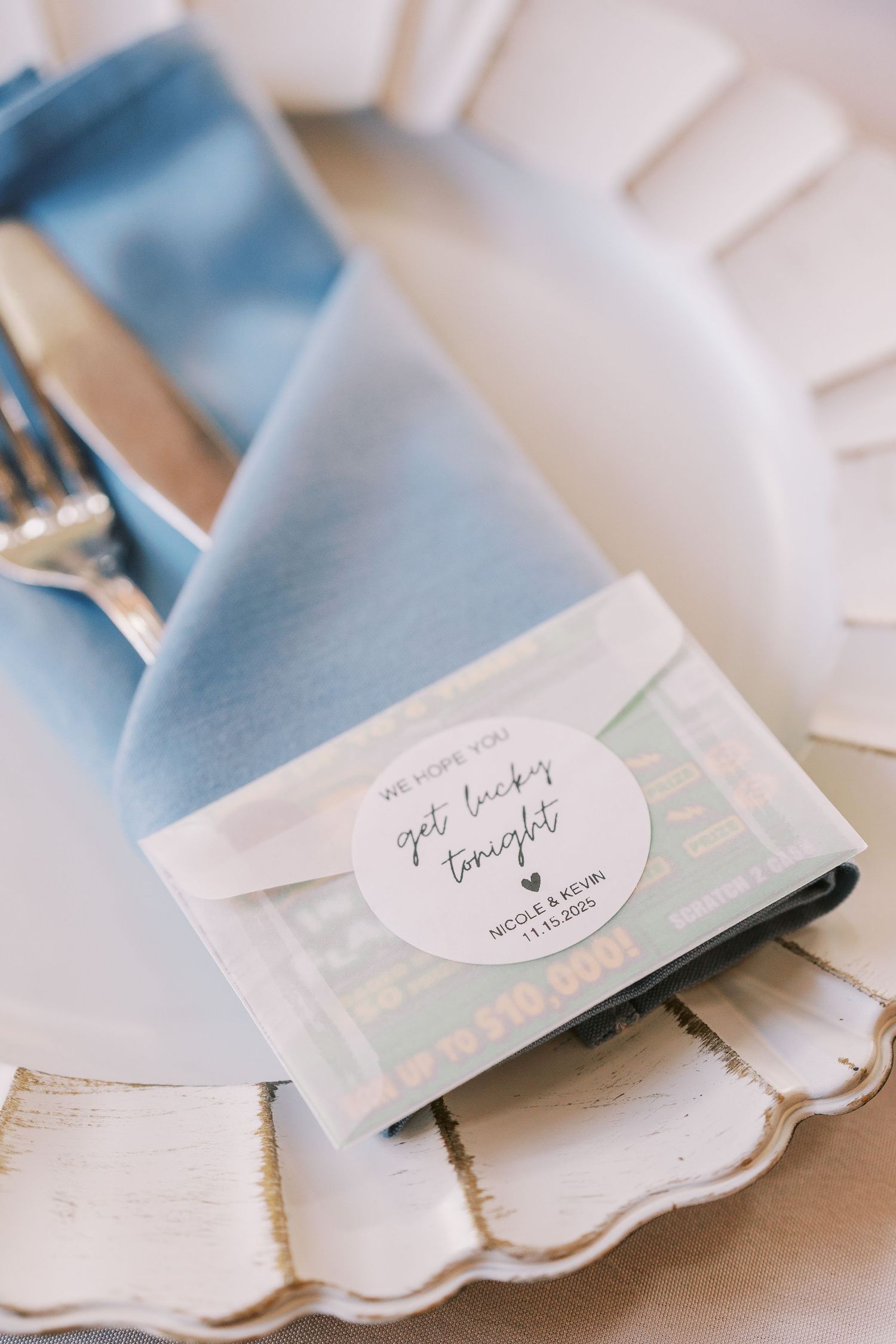 Light blue silk handkerchief with delicate scalloped edges and handwritten name tag displayed in soft natural light.