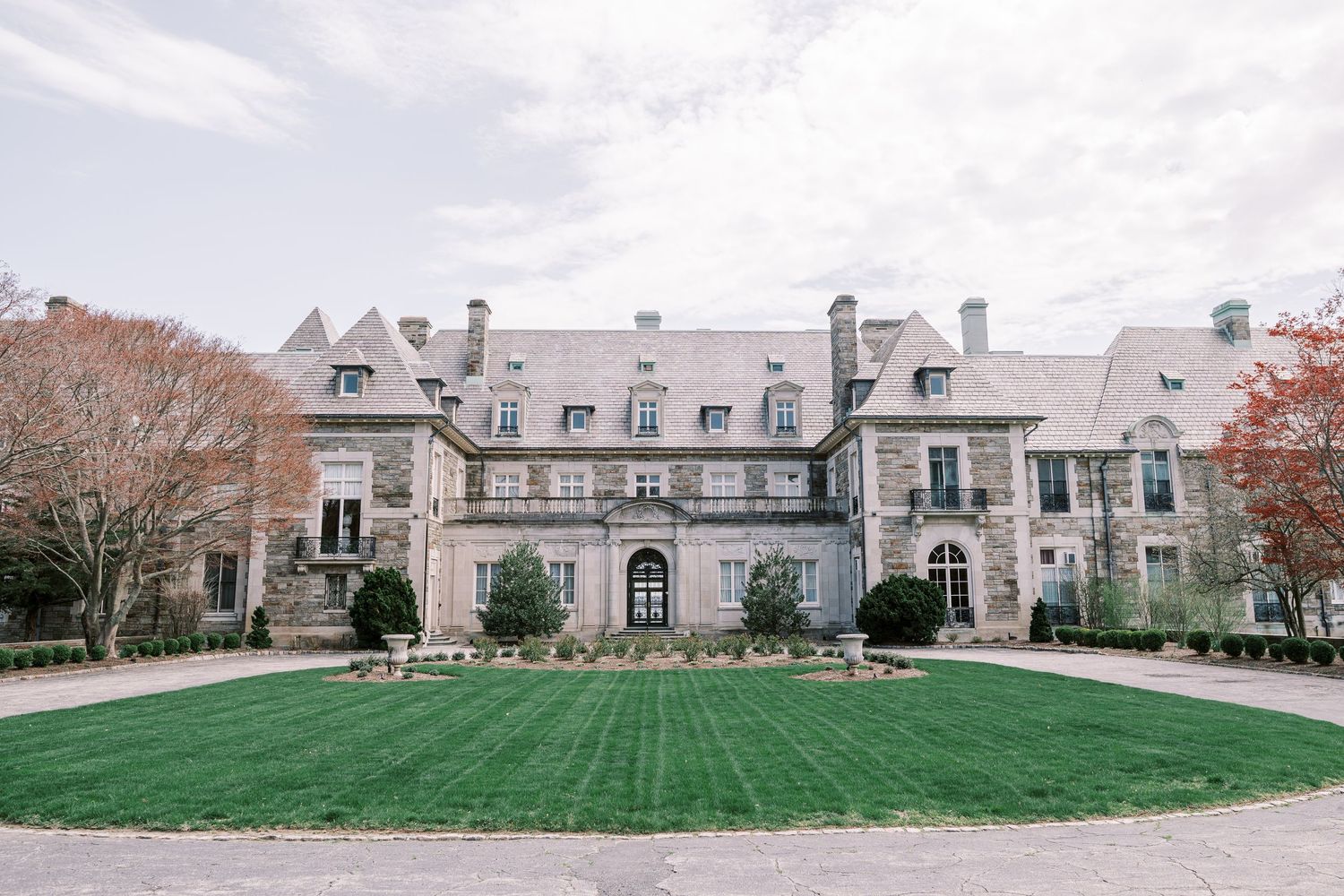 Elegant stone mansion with manicured lawns and classic architectural details viewed from different angles.