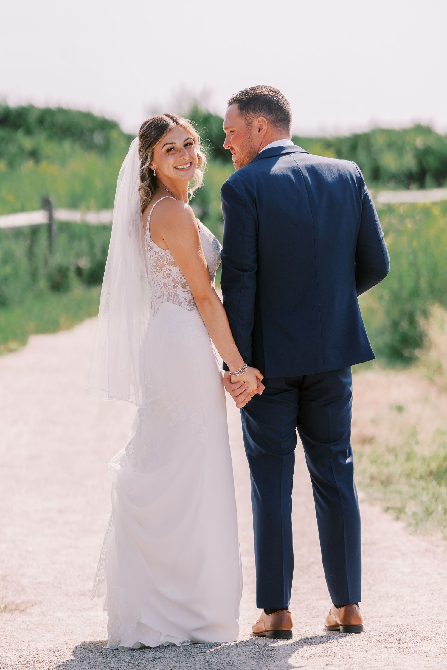 A romantic sequence of wedding photos showing a bride and groom walking together on a sunlit outdoor path.