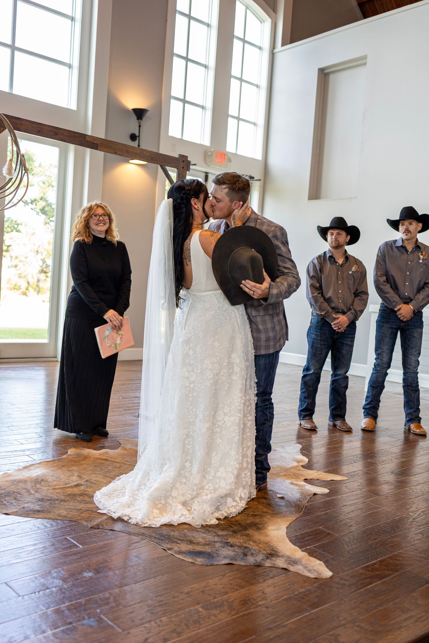 A sequence of romantic first dance moments at a rustic wedding venue with wooden floors and large windows.