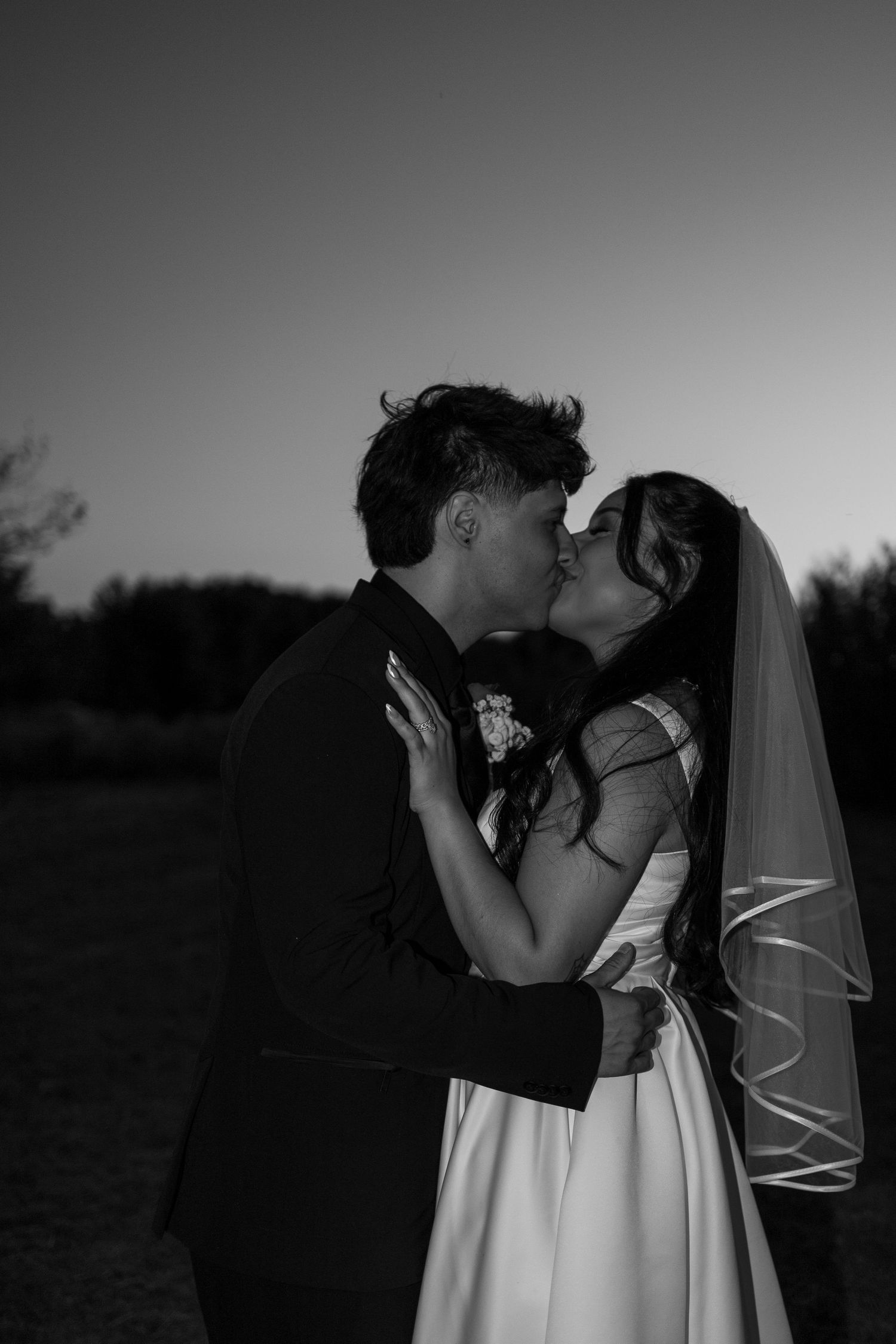 A romantic black and white wedding photo sequence showing a couple sharing tender kisses in outdoor settings.