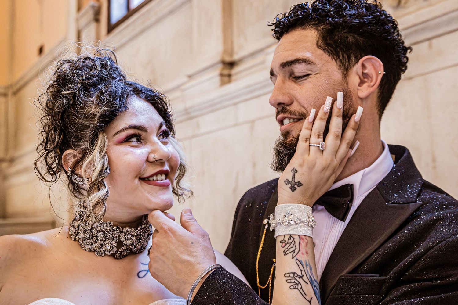 Newlyweds sharing joyful moments in an elegant indoor setting.