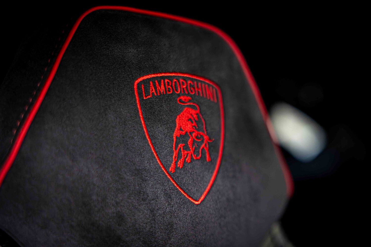 Series of red Lamborghini logos against black backgrounds creating a minimalist automotive design sequence.