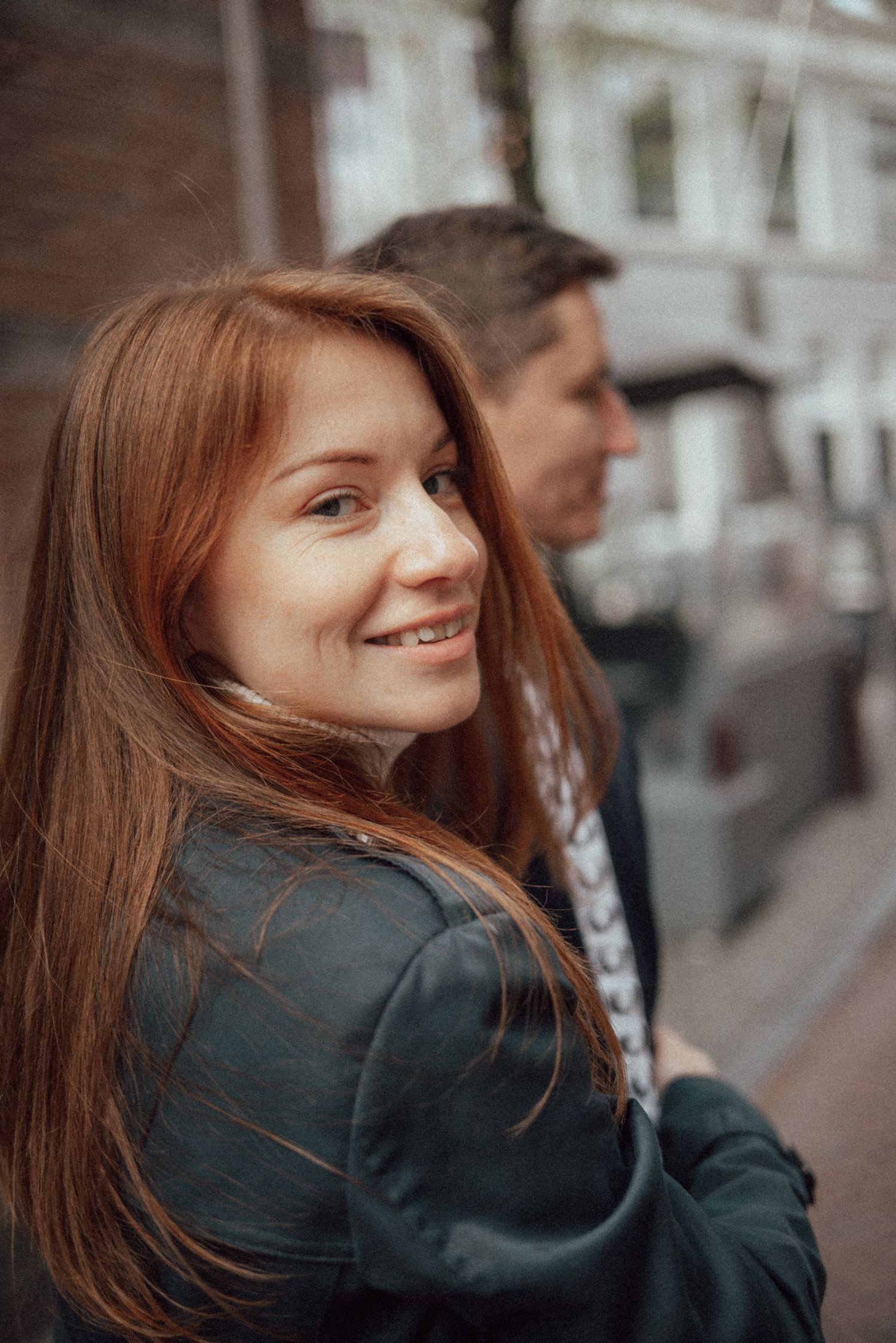 Street scene with person turning and looking back over shoulder.