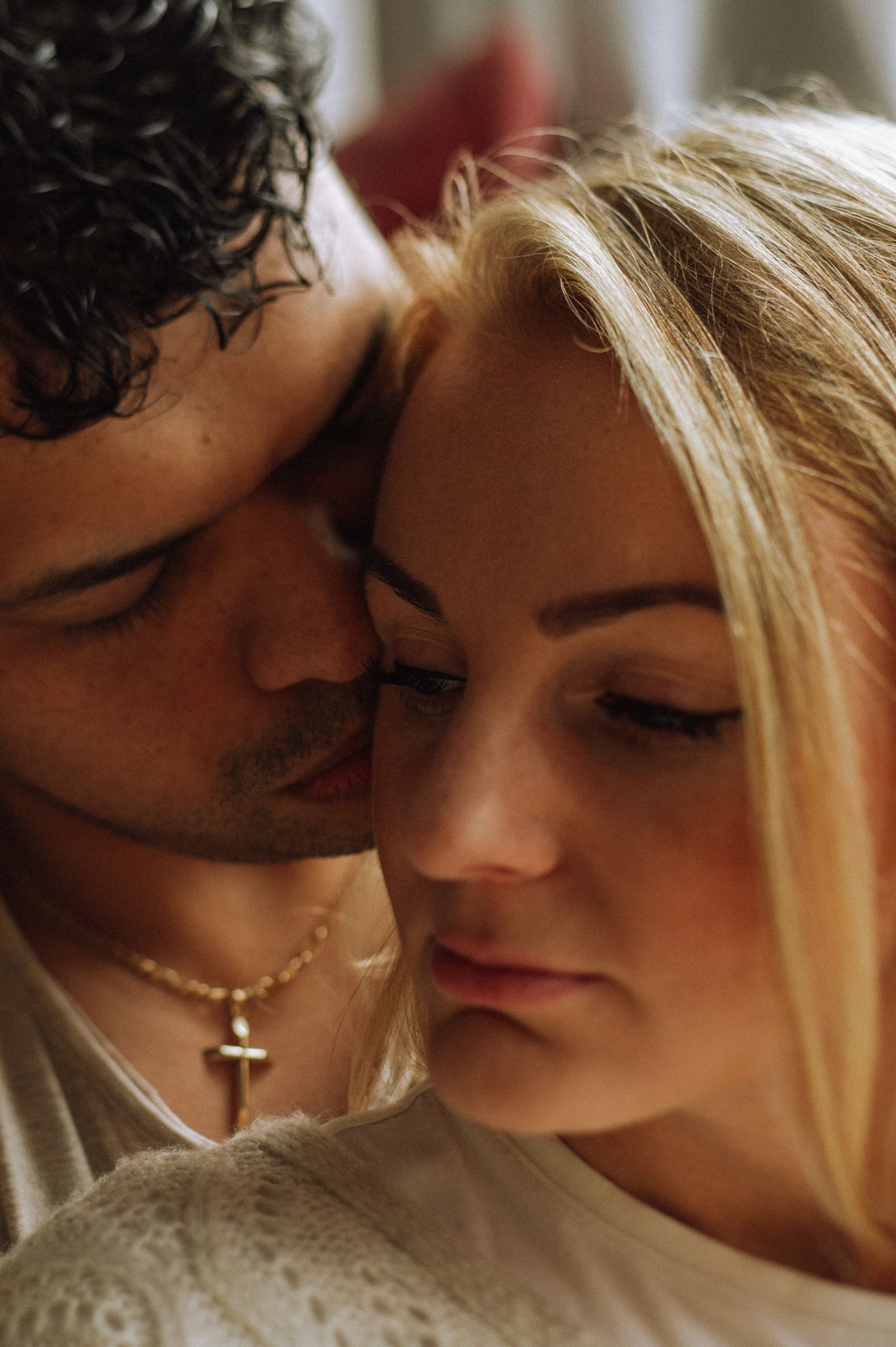 Close-up intimate portrait of couple sharing tender moment.