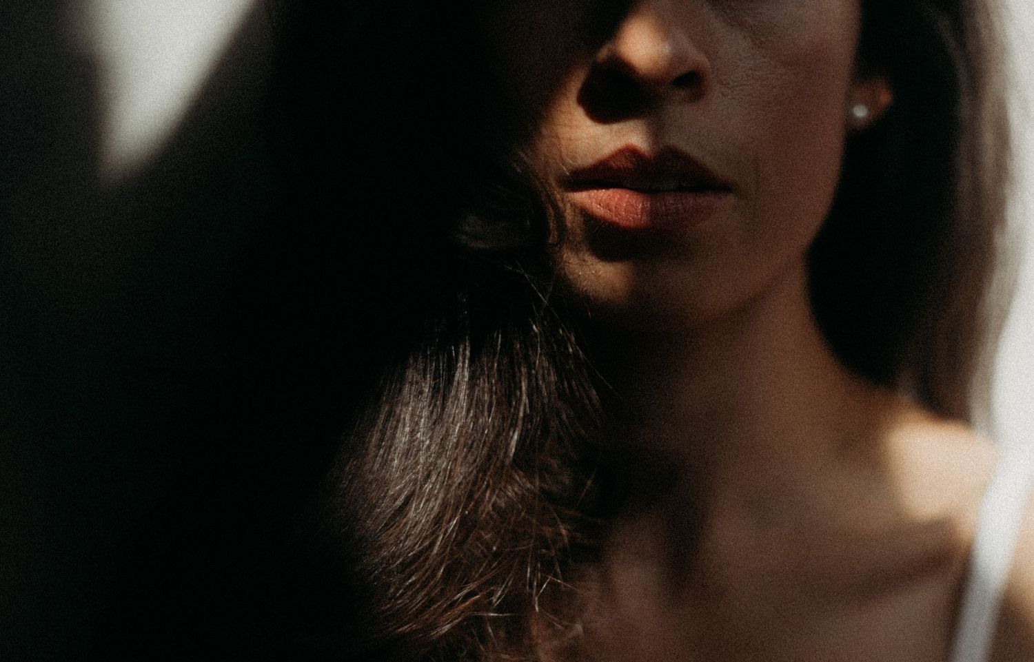 Close-up portraits showing lips and facial features in dramatic lighting.