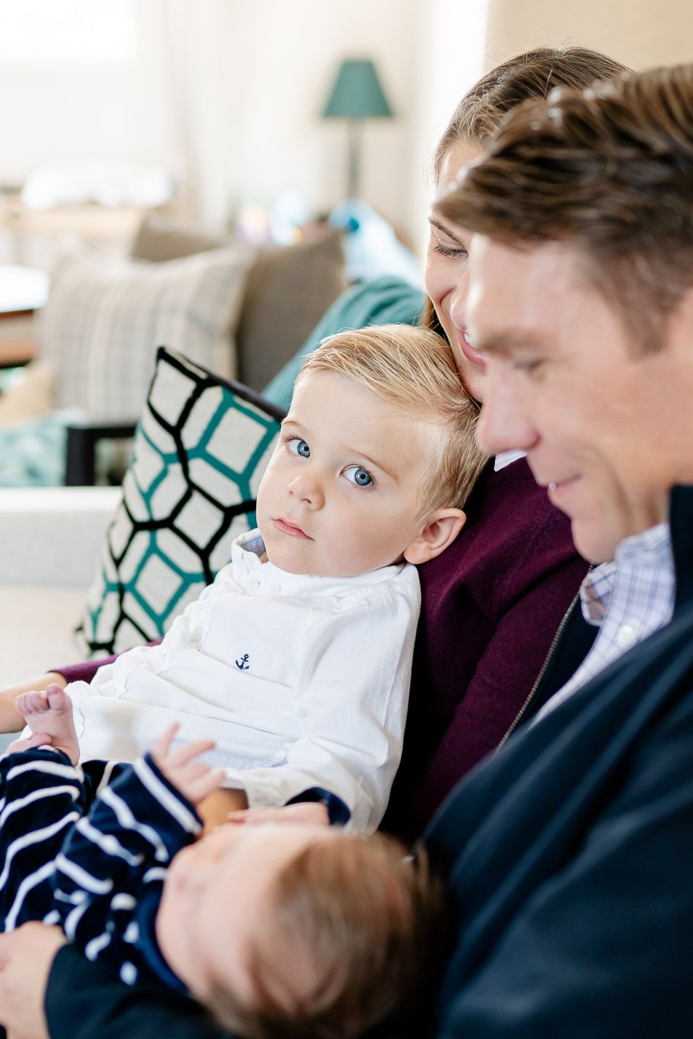 Newborn in dads arms during an intimate family portrait session in the home in san san clamente, CA