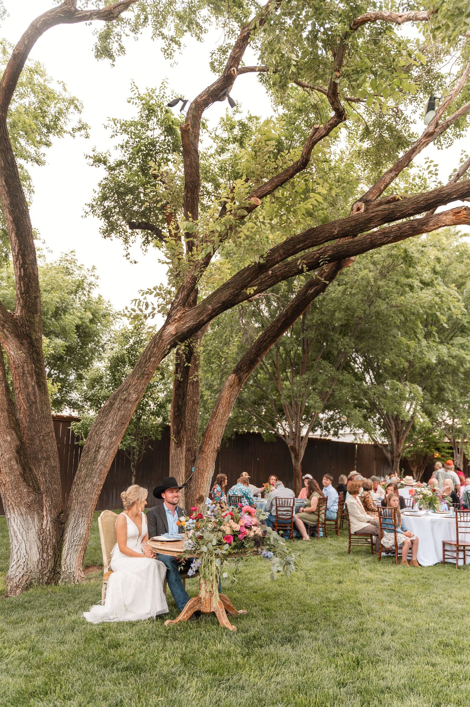 A wedding couple and their guests enjoying the reception