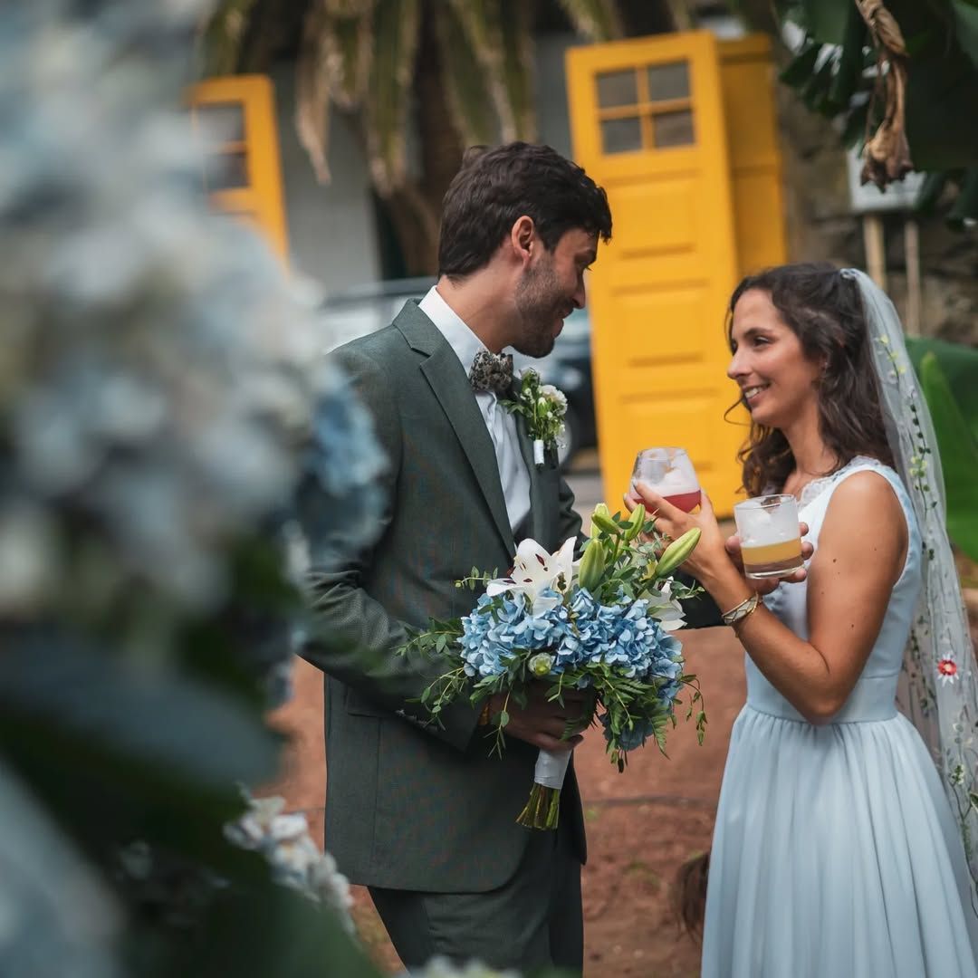 Groom and bride smiling with bouquet – authentic Azores destination wedding moment