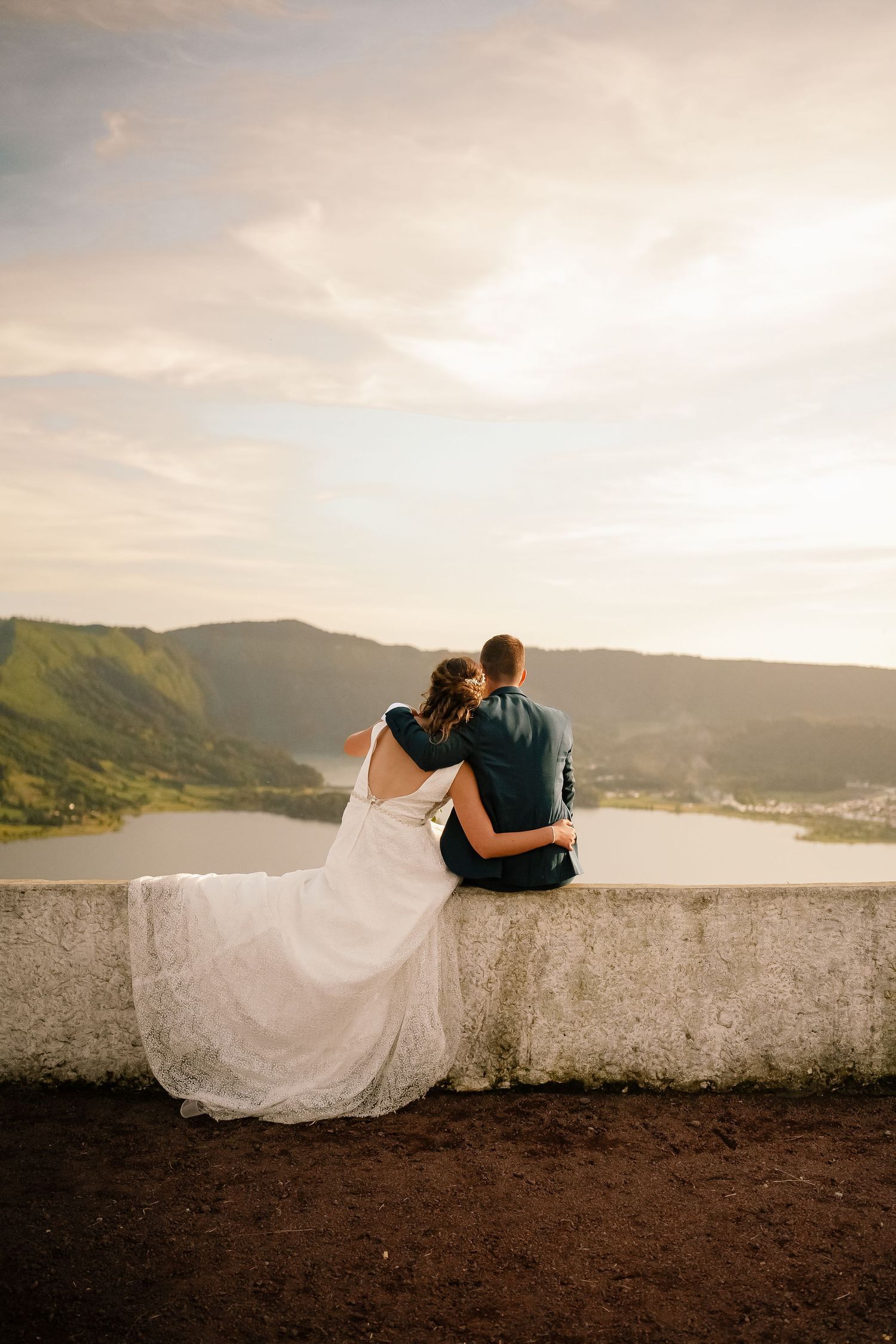 Couple sitting on volcanic viewpoint – intimate São Miguel elopement photo