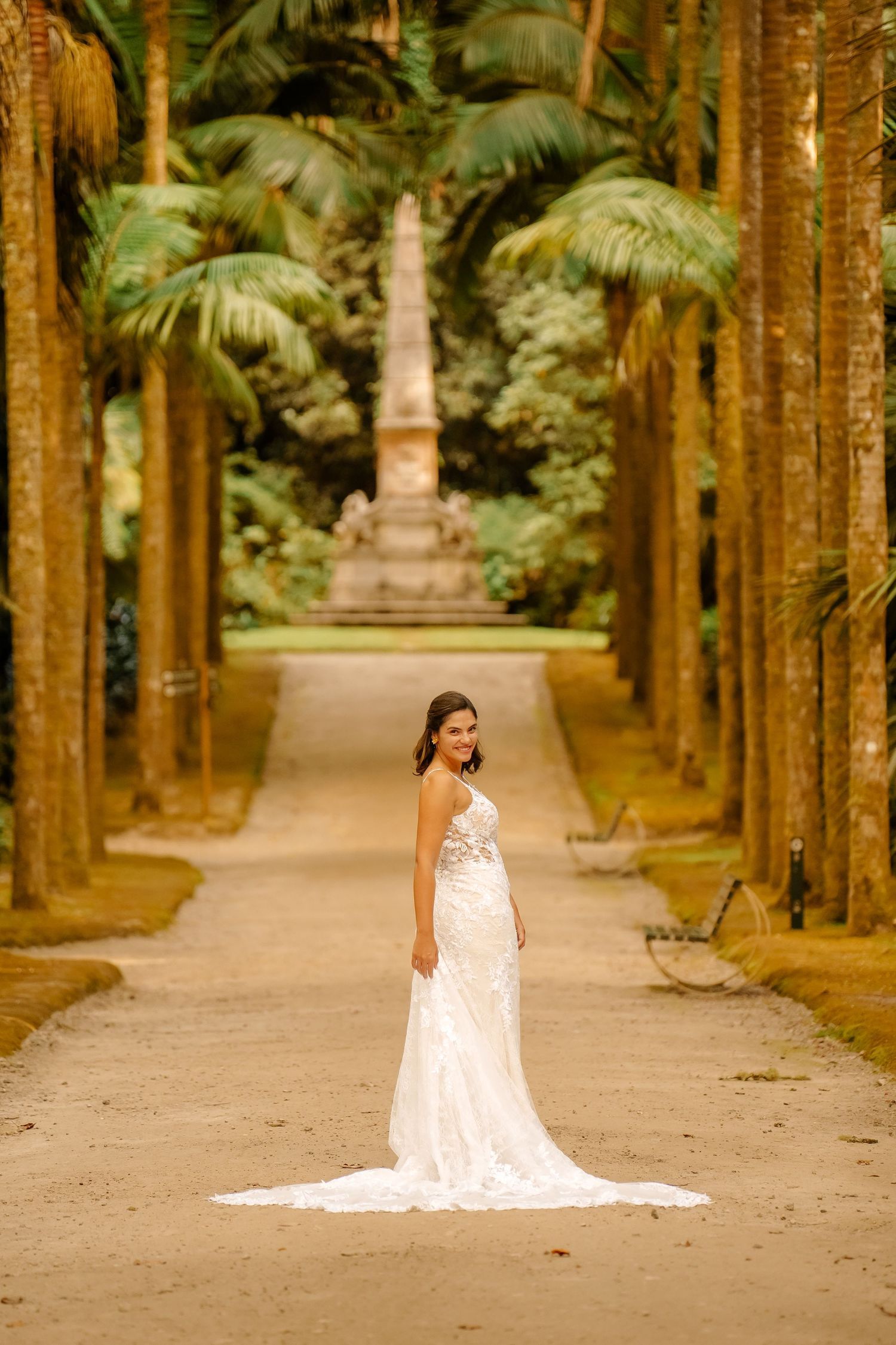 Bride standing between palm trees in Terra Nostra Park – tropical wedding in São Miguel, Azores