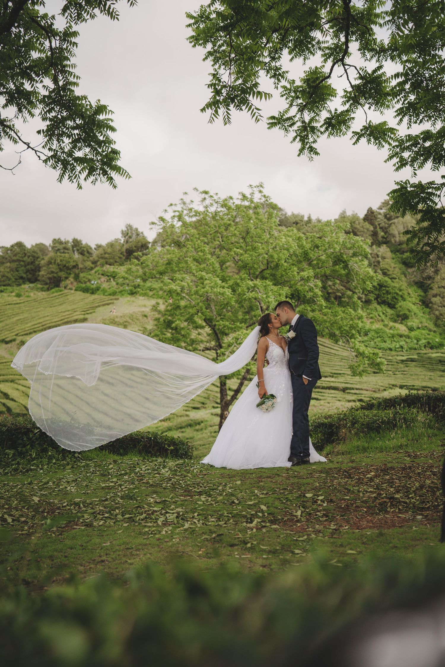 Bride in natural garden setting – authentic Azores elopement experience under lush trees