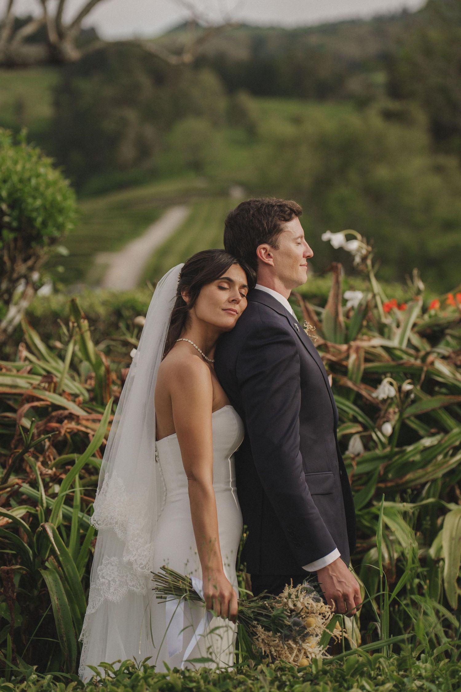 Azores wedding photographer capturing a kiss between hydrangeas in São Miguel