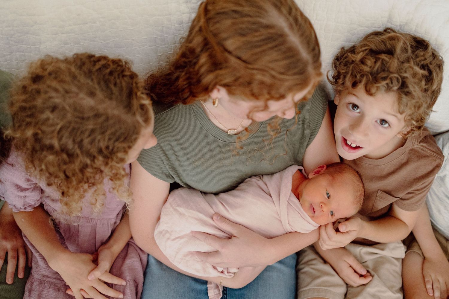 A series of intimate newborn photography shots showing gentle parent-baby moments in soft, natural lighting.