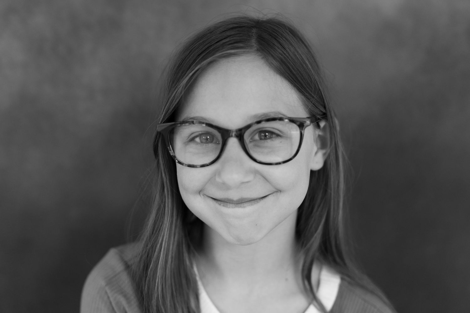 A collection of portrait photographs showing different expressions and poses against a dark background.