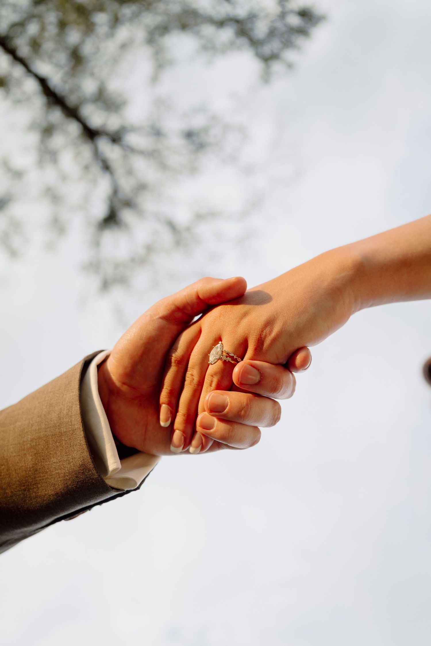 Professional business handshake sequence showing hands coming together against a light background.