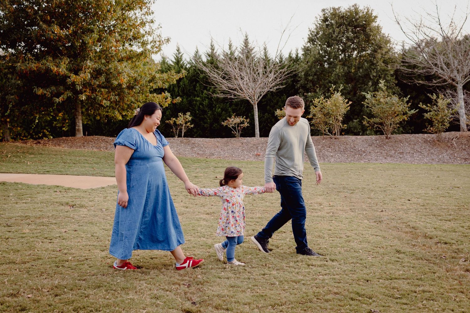 A series of candid outdoor family moments captured in a park setting during autumn with people walking and playing together.
