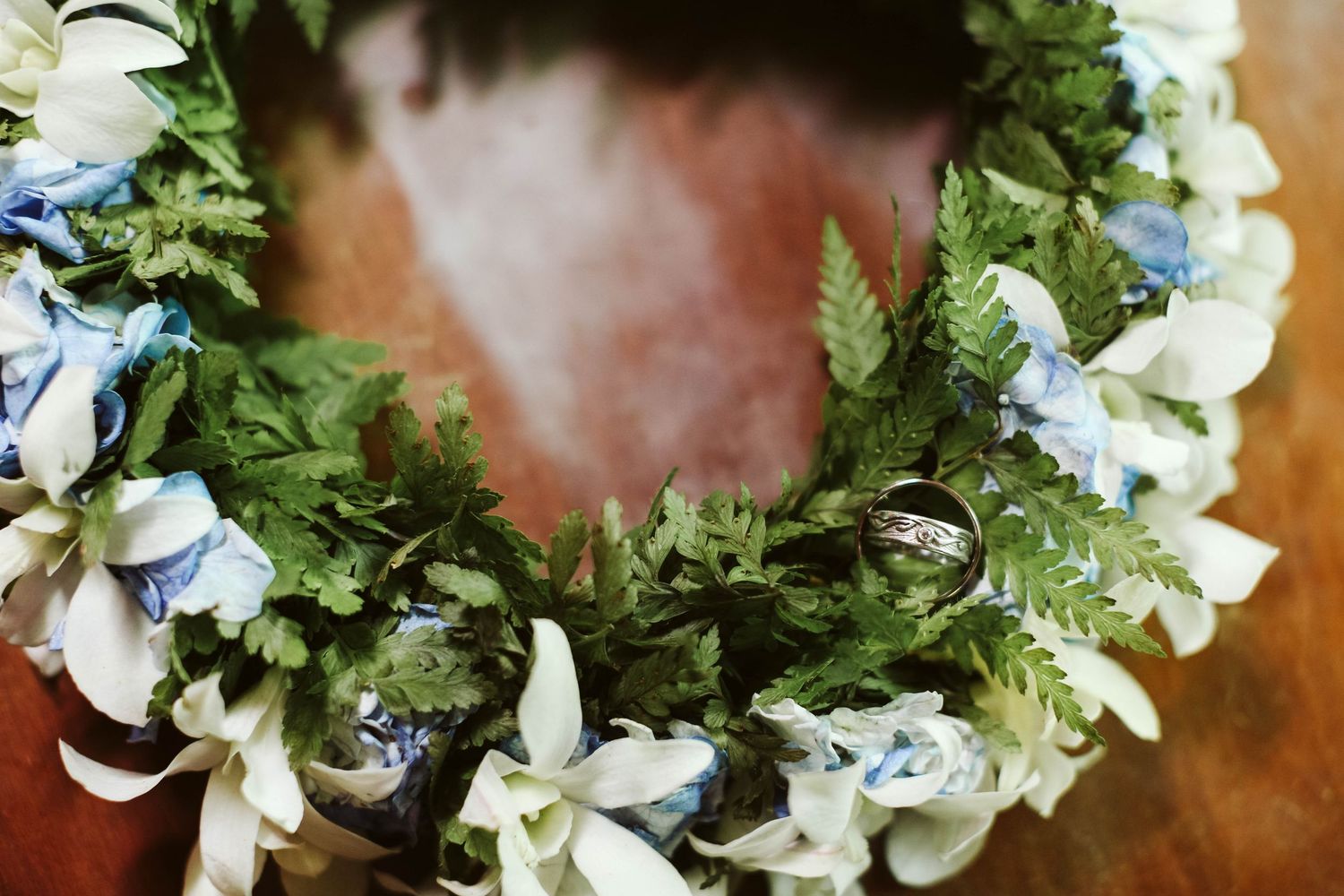 A delicate floral crown made with white flowers and green foliage for a wedding.