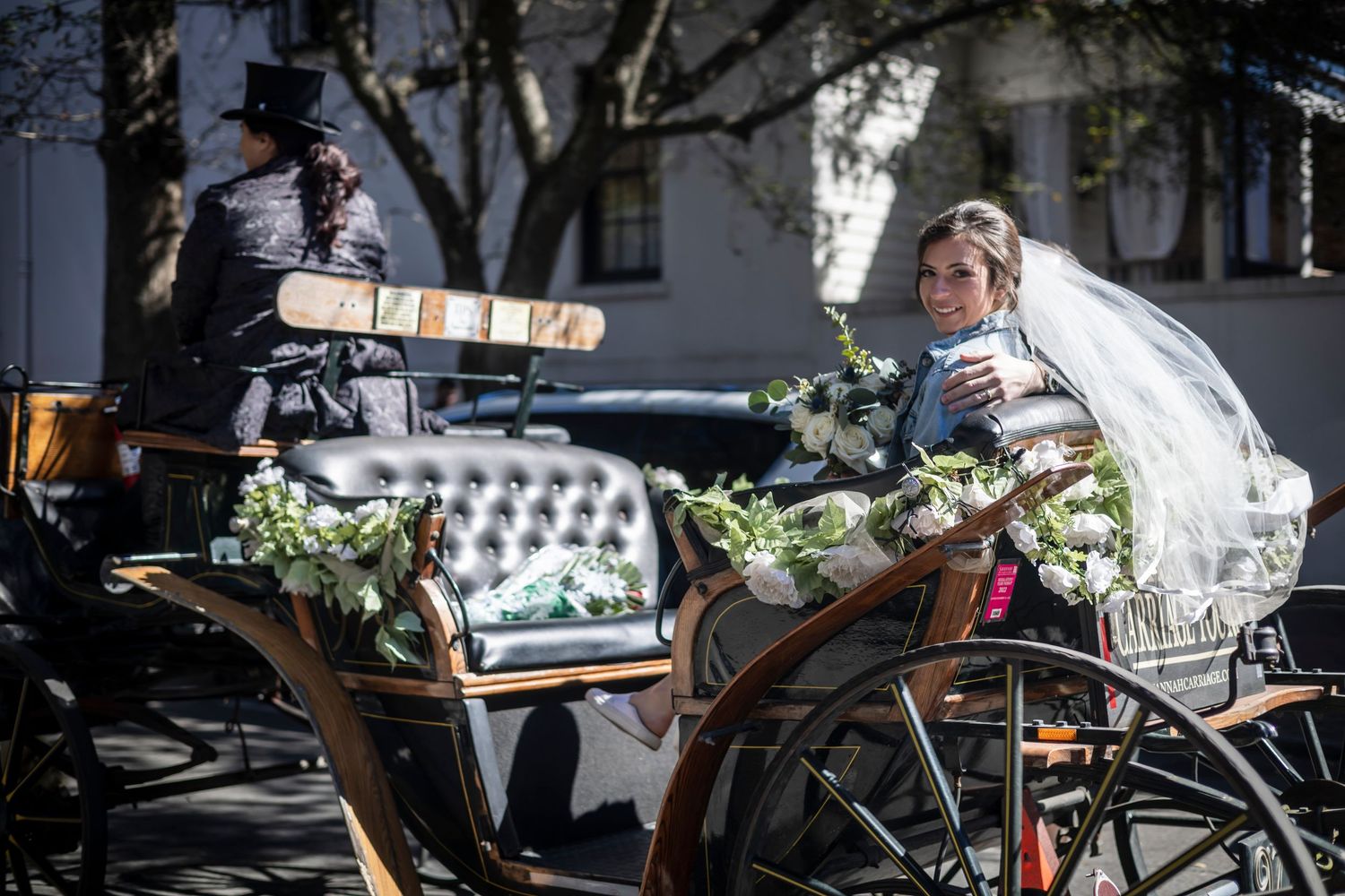 Vintage bicycles decorated with flowers and wedding decor leaning against a rustic wall.