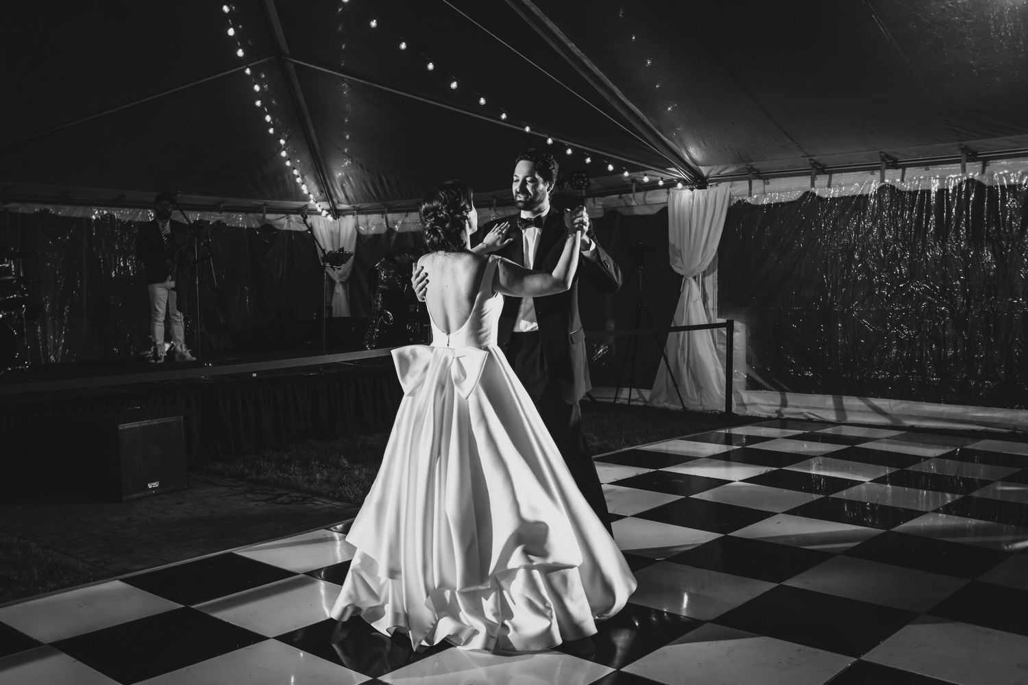 Black and white dance floor photos showing elegant wedding reception setup with hanging lights.