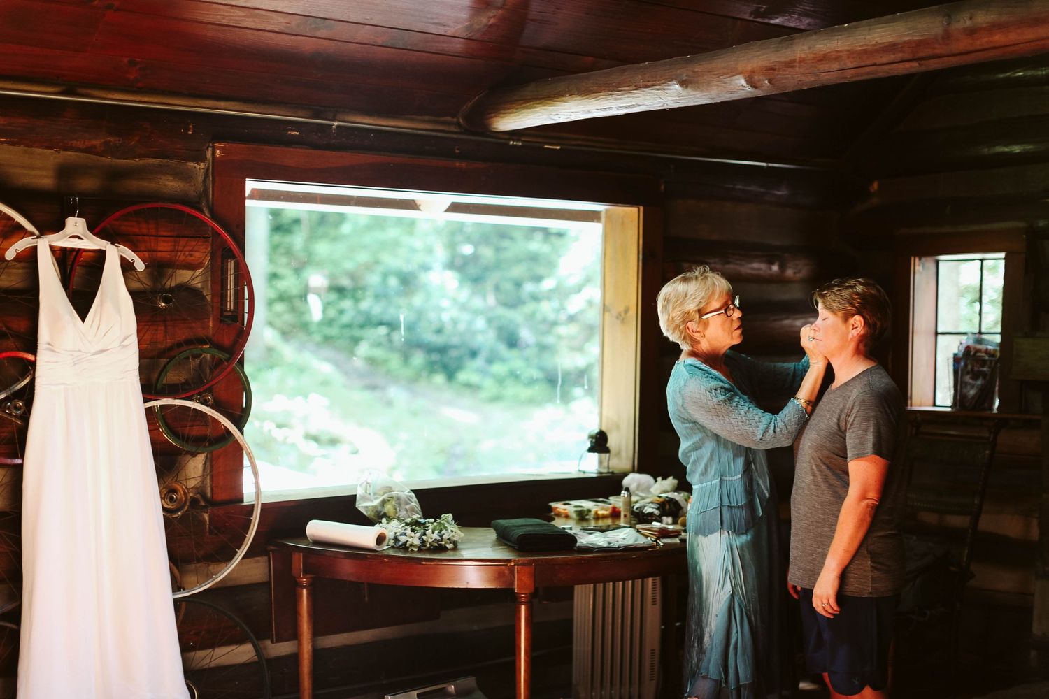 A rustic wooden cabin interior with wedding preparations underway.