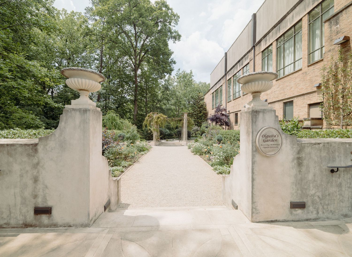 Stone pathway leading to building entrance with concrete railings.