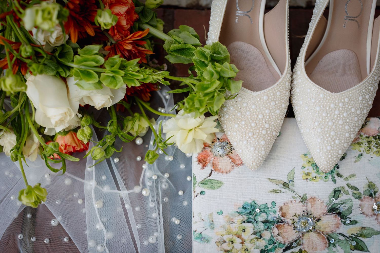 Elegant wedding decor featuring white and green floral arrangements with delicate lighting details.