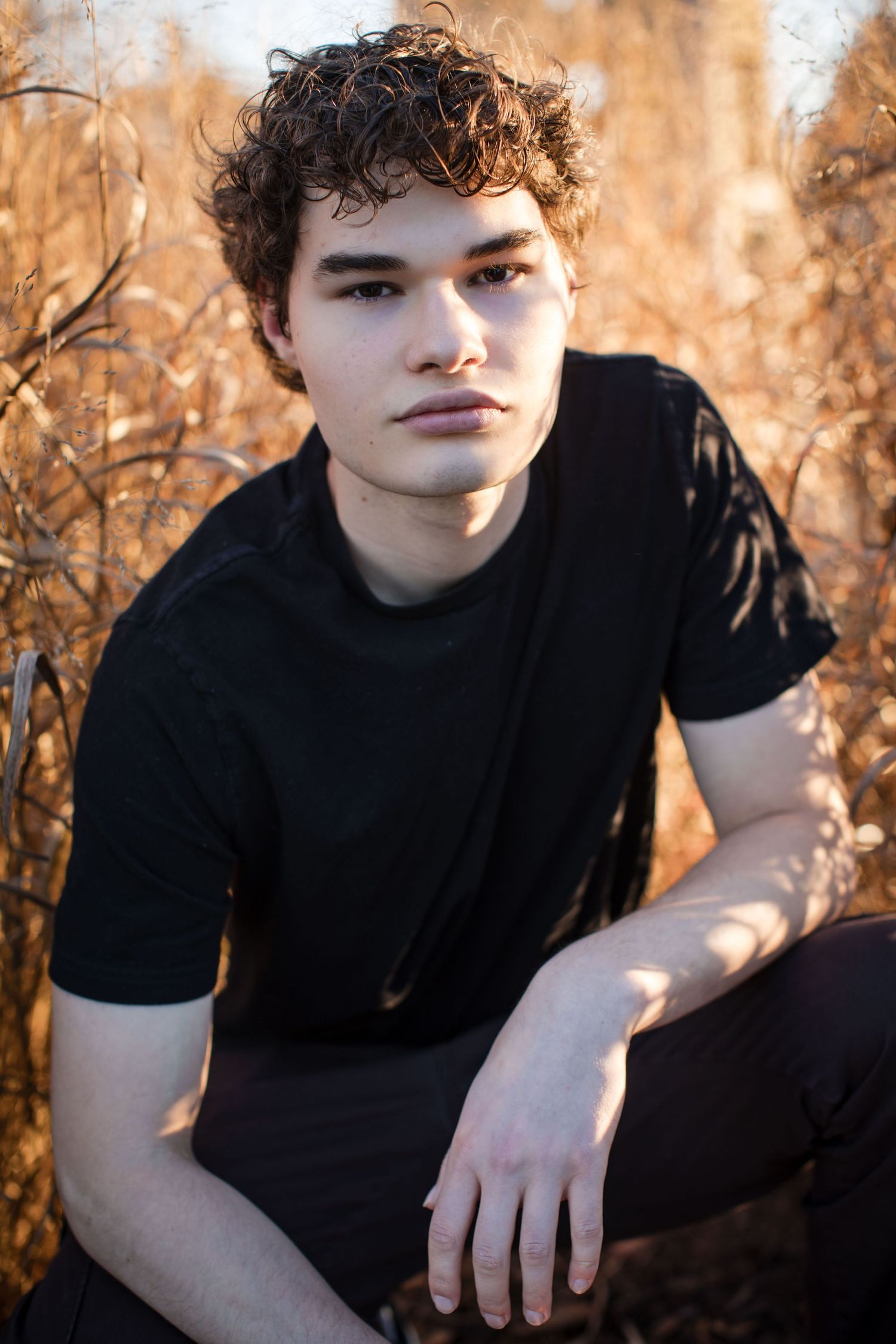 A series of outdoor portrait photos showing someone in a black t-shirt against an autumn background with warm lighting.