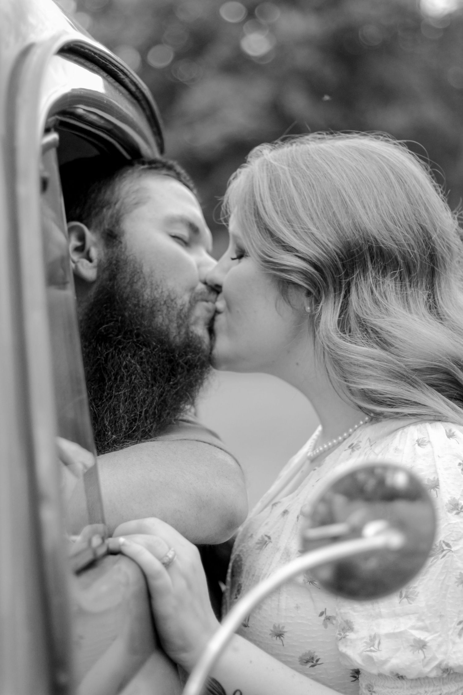 A romantic black and white photo series capturing a tender kiss between a couple.