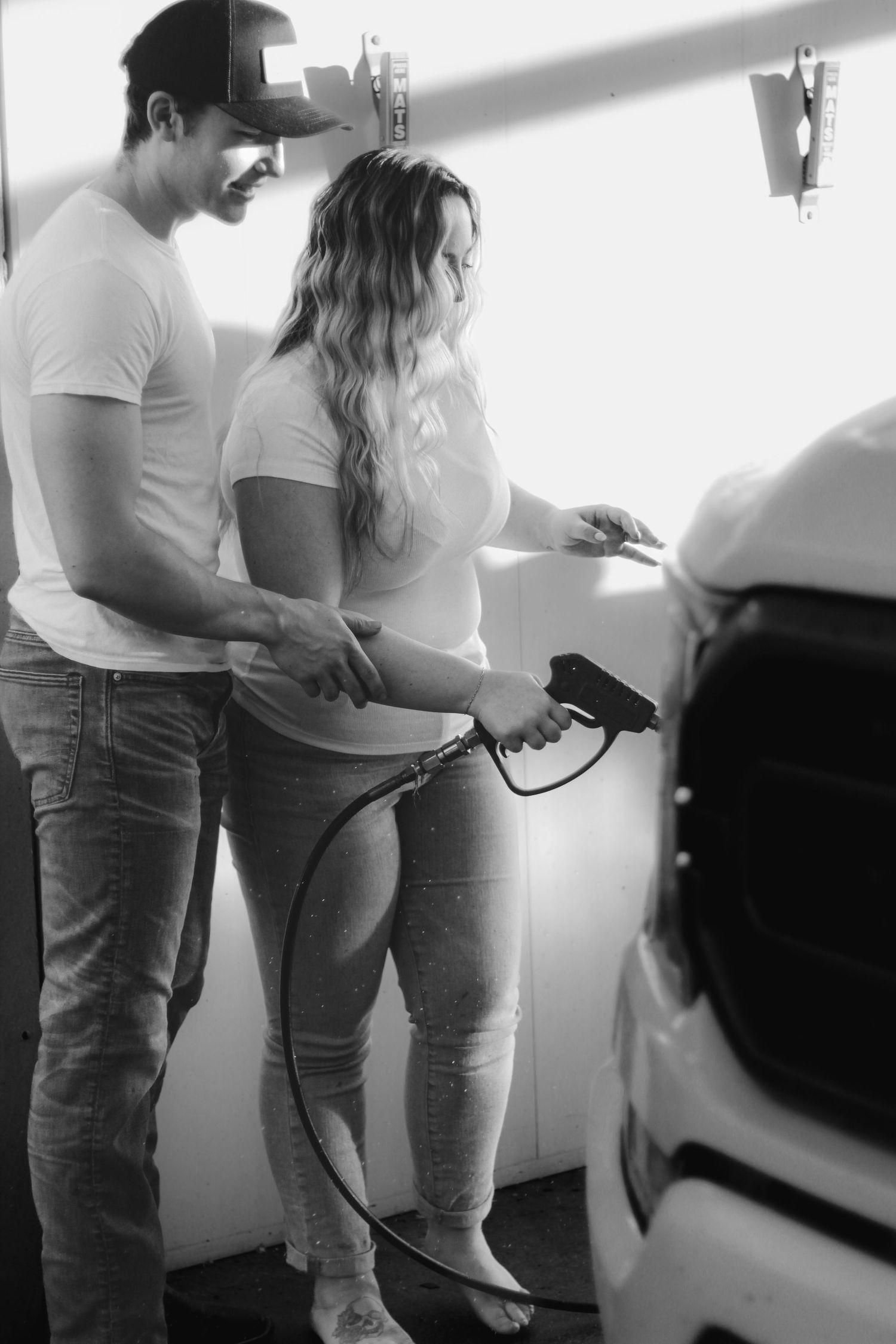 Series of black and white photos showing intimate moments near a car.